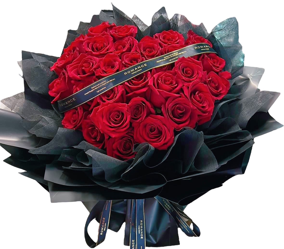 Bouquet of red roses wrapped in dark paper with a ribbon