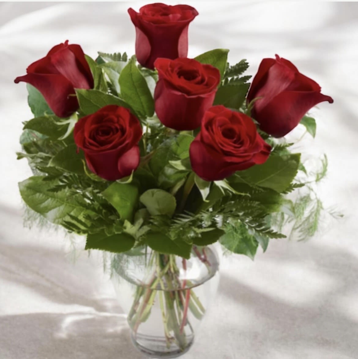 Half Dozen roses  - This arrangement has six roses, greens and a clear glass vase. If you would like to add baby’s breath it will be an additional seven dollars. Please give us a call if you would like to add baby’s breath so we can make sure it will be added to the order. Or you can click on the deluxe that is with baby’s breath added. 