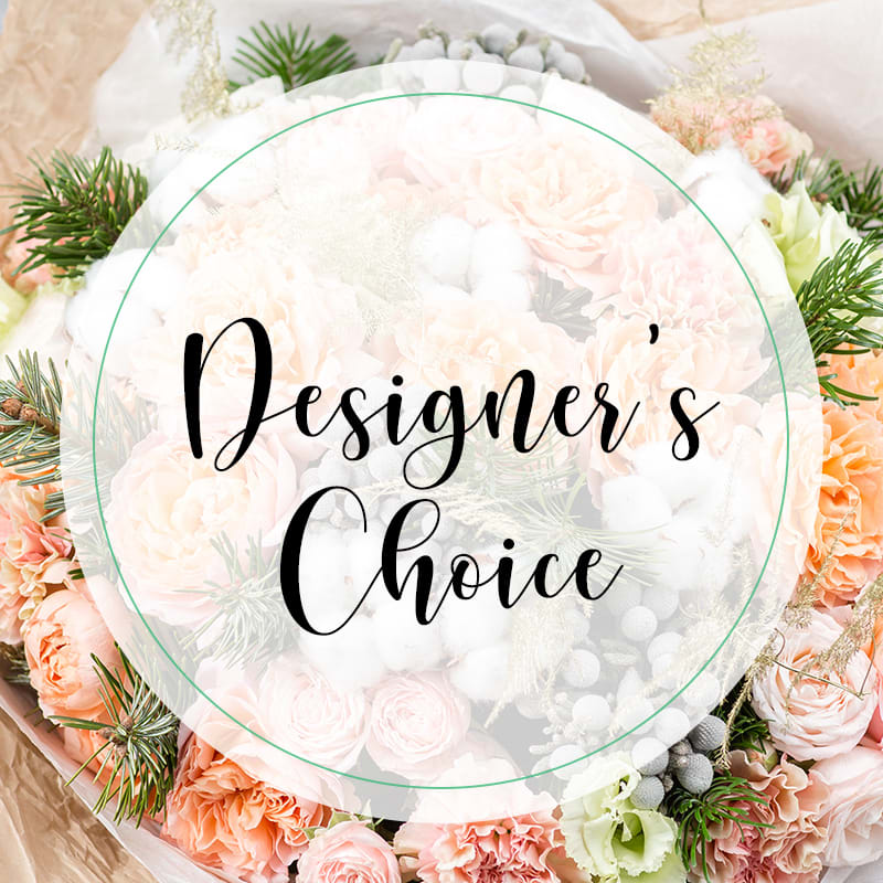Round floral arrangement with pale pink and white blooms and pine accents