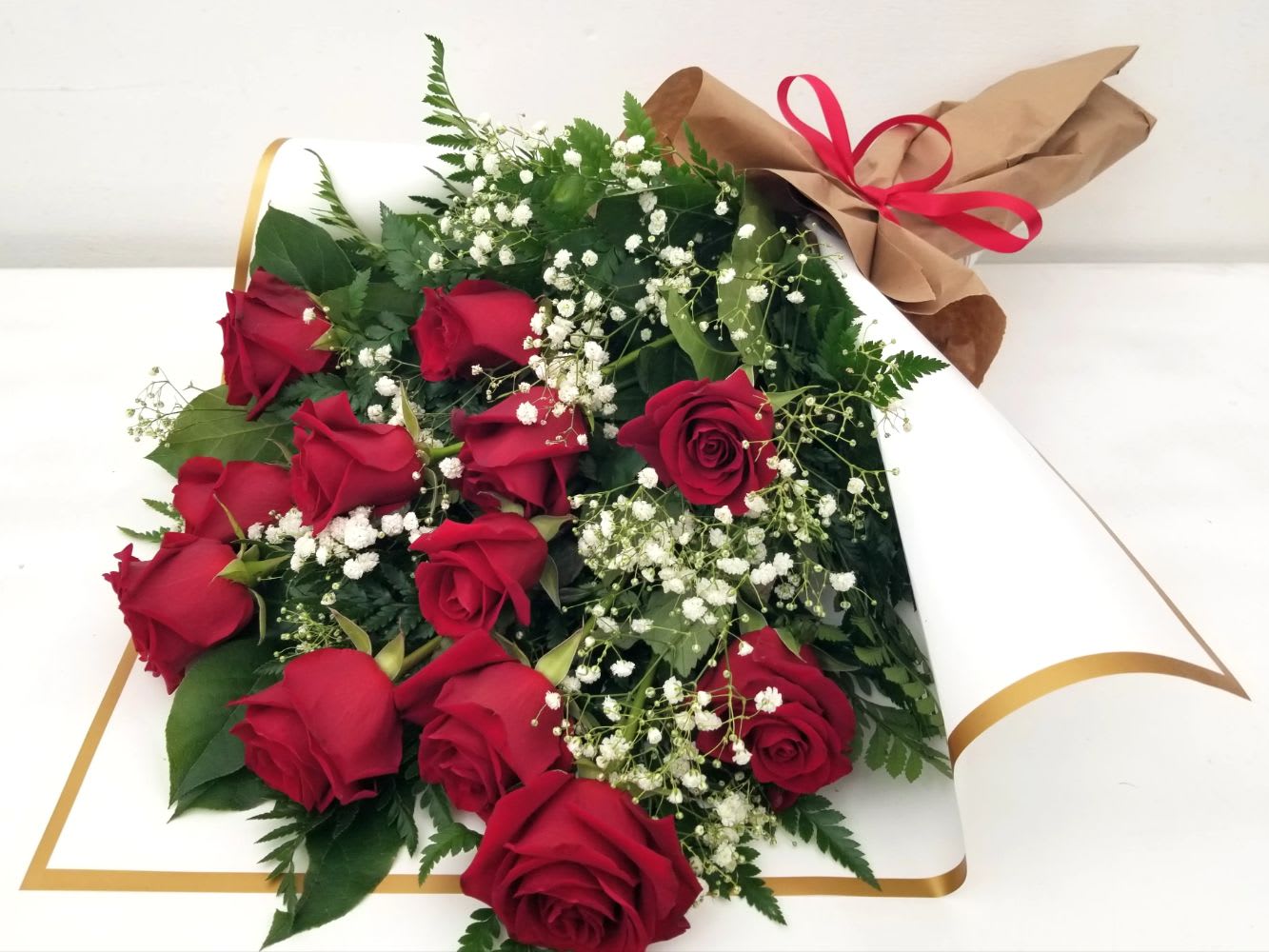 Beautiful Artisan Wrapped Red Roses - Local Long Beach Flower Shop ABC! - A beautiful presentation to your love or someone special. Gorgeous long stem RED roses, with accent flowers and lush greenery, artfully wrapped and tied with raffia or satin bow.  CHOOSE YOUR SIZE:  STANDARD - (pictured) is One Dozen (12)   DELUXE - Eighteen (18) PREMIUM - Two Dozen (24) roses.   Same day order, delivery or pick-up here at our shop. Other colors, mixed color available, give us a call 562-437-4106. Wrapped Roses from Long Beach favorite flower shop, A Beautiful California Florist.  Now located at 611 E Carson Street, Suite B, Long Beach, CA 90807