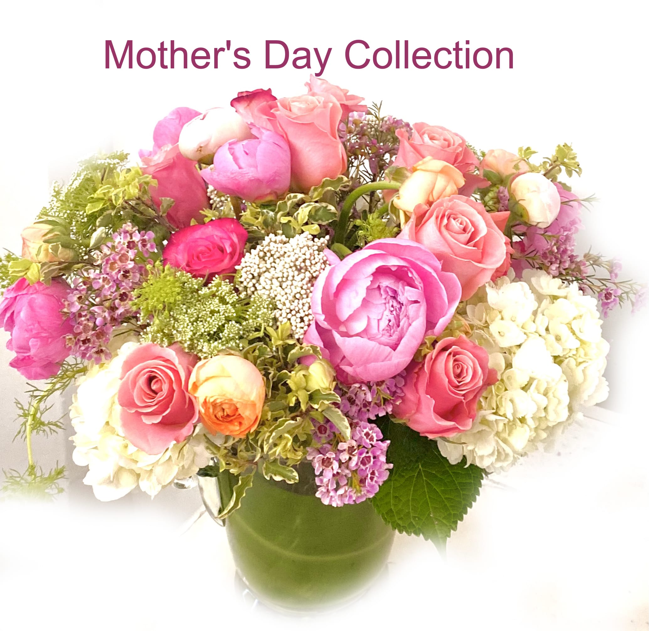 Mother's Day Collection - Spring Opulence - Available May 2nd trough May10th Pink and purple blooms artfully arranges in a vase.