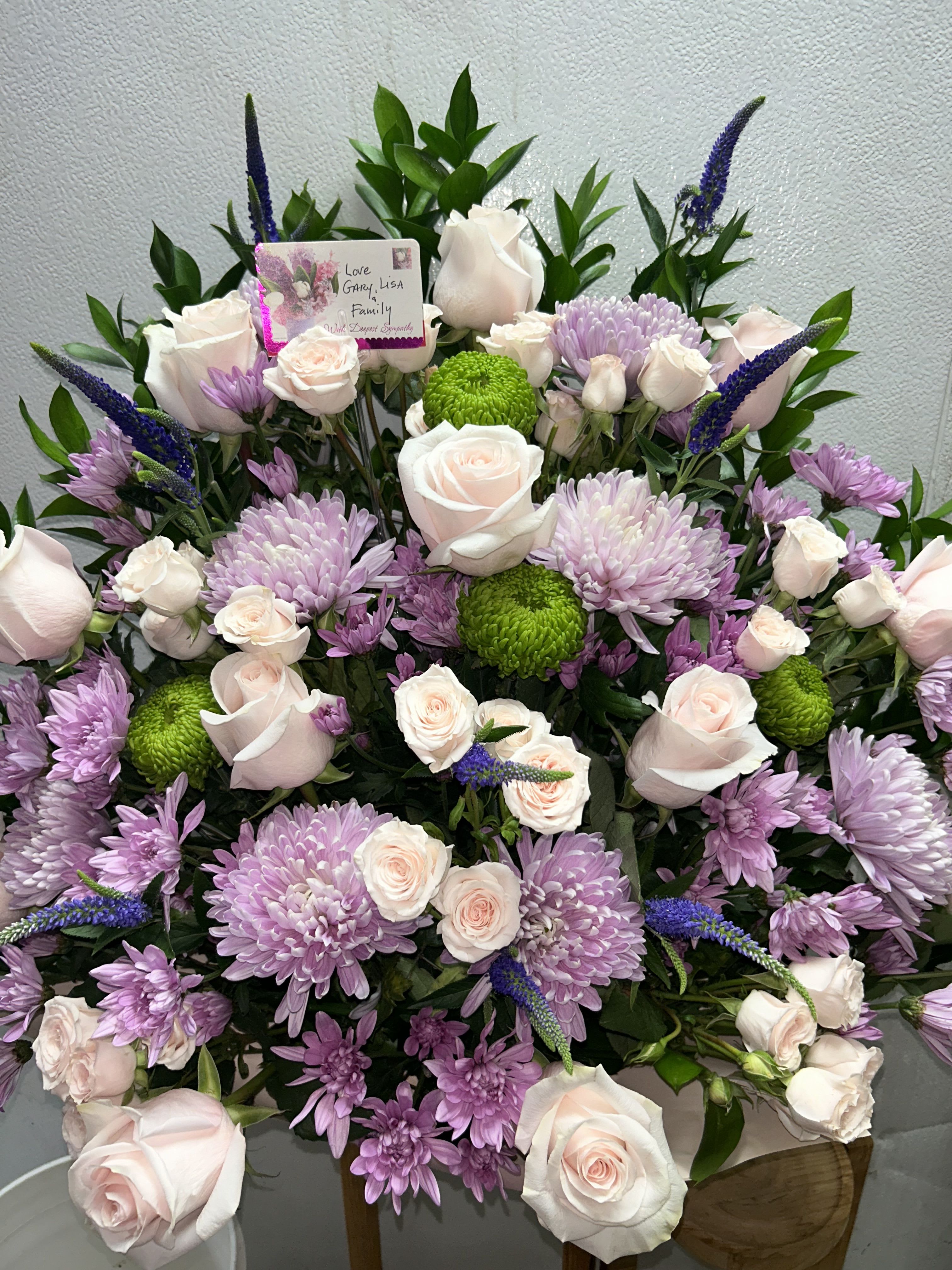 Large bouquet of pale pink roses, lavender chrysanthemums, and green button mums
