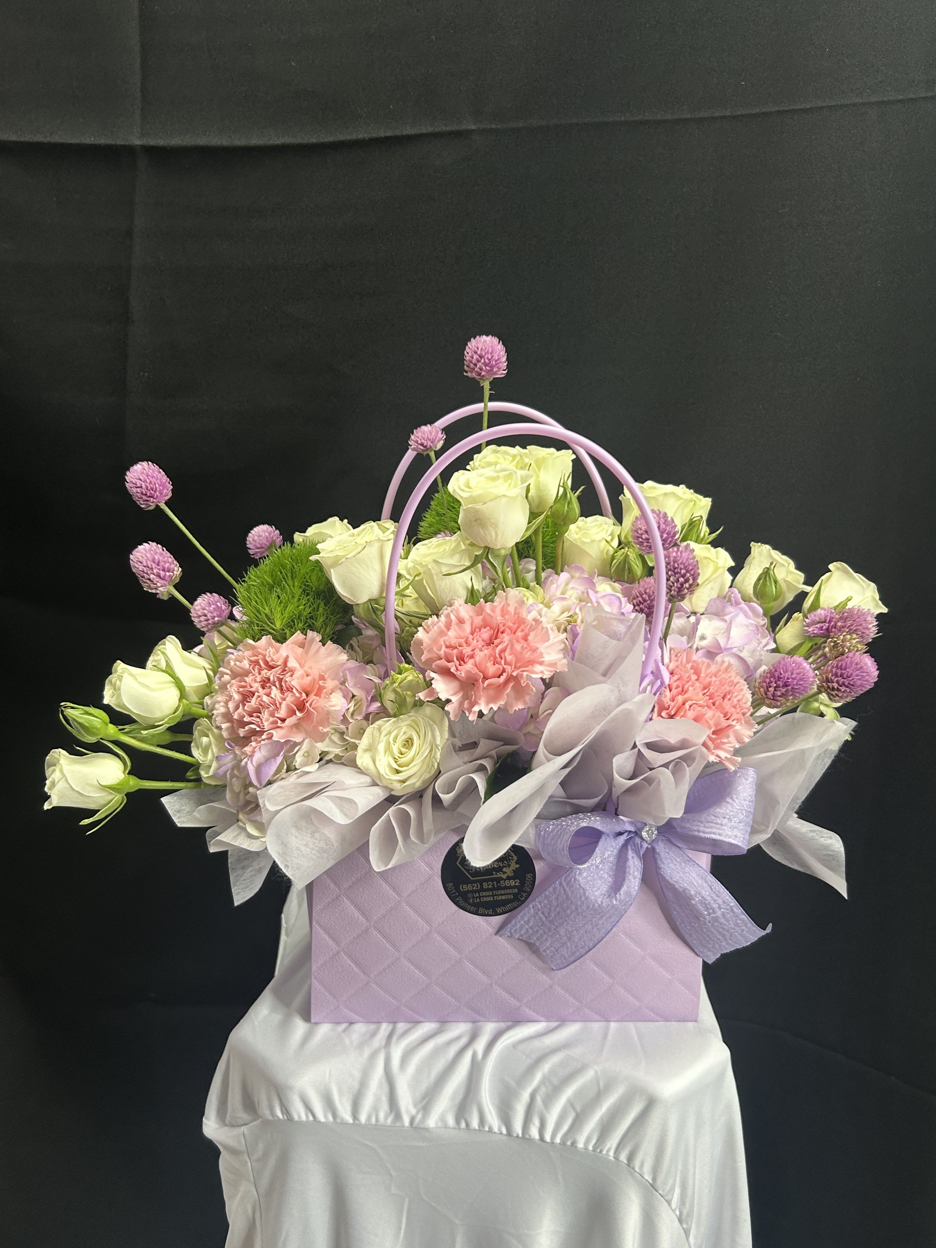 Lavender gift box with pastel roses, carnations, and purple accents