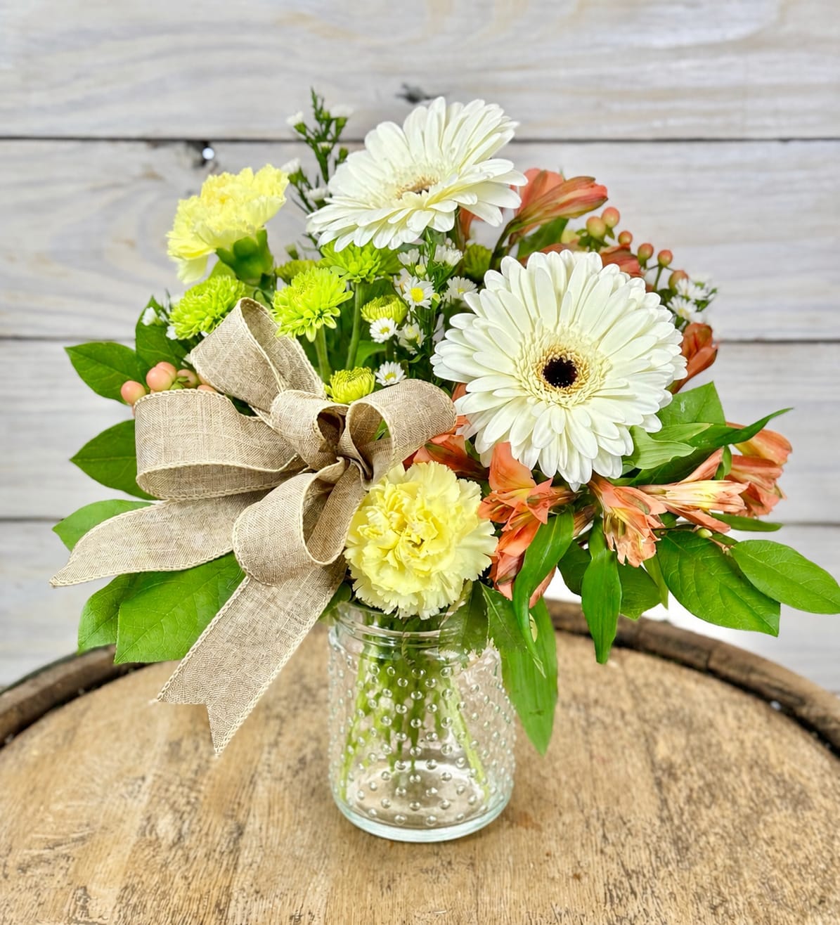 Peaches and Cream - A cute and rustic flower arrangement nestled in a clear hobnail jar.