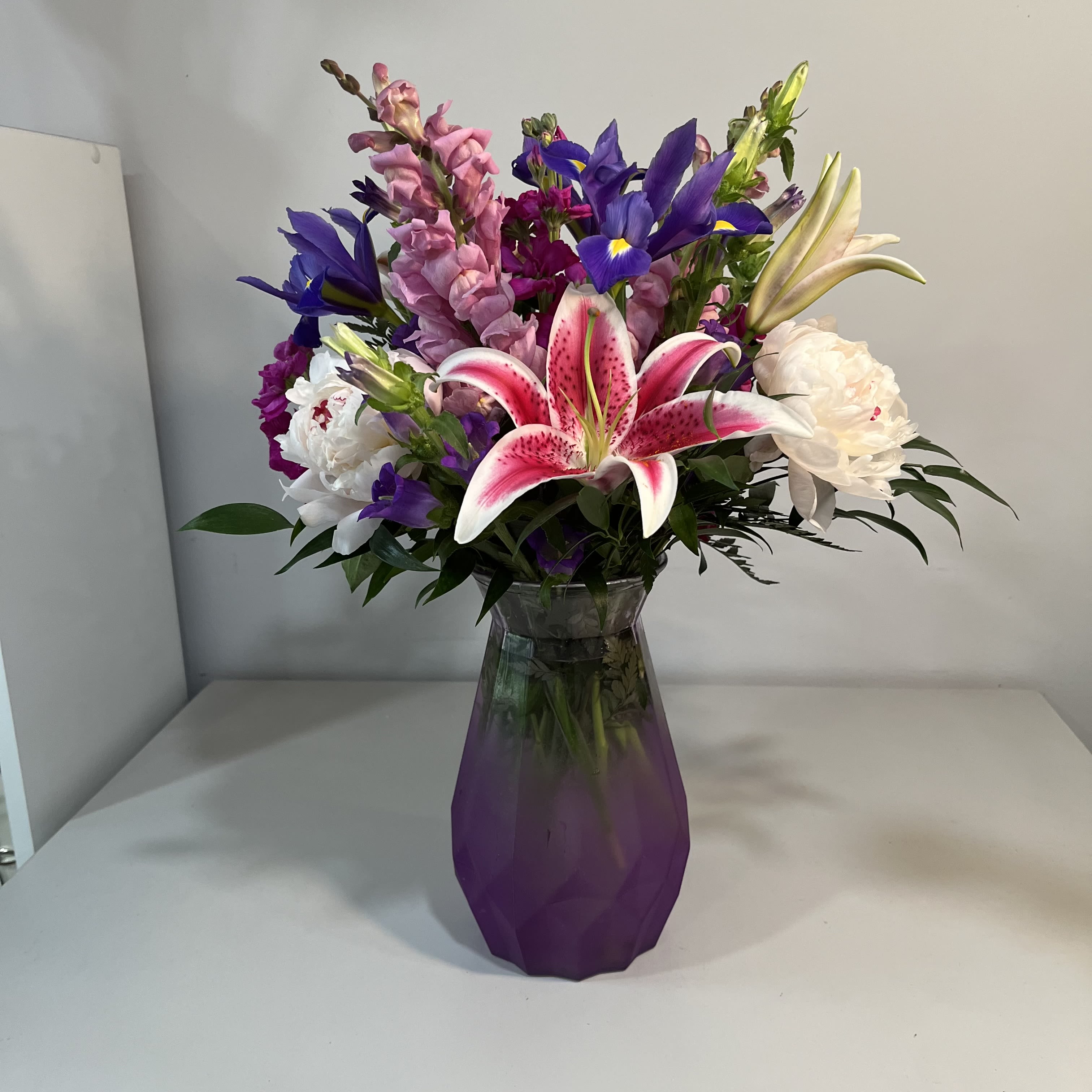Pretty in Purple - Beautiful Frosted Purple Vase filled with Lavender Snapdragons, Peonies, Roses, Oriental Lilies, Campanula and Iris (Product may be substituted due to availability)