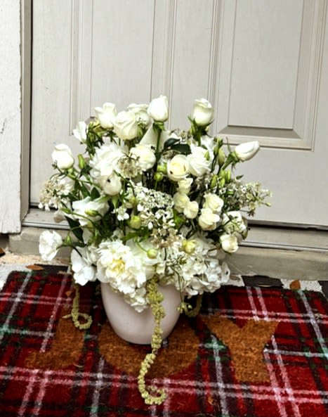 Elegant White Garden Arrangement - A luxurious white flower arrangement in San Antonio featuring fresh white roses, hydrangeas, lisianthus, stock flowers, and delicate seasonal greenery designed in an elegant ceramic container. Handcrafted by Snyder Flowers San Antonio, this sophisticated floral design offers a timeless and graceful look perfect for sympathy, weddings, anniversaries, birthdays, or meaningful gifts.   We proudly offer same-day flower delivery in San Antonio with fresh premium flowers and exceptional customer service.  Elegant floral designs created with high-quality blooms and modern garden style arrangements.  Serving Stone Oak, Medical Center, Alamo Heights, Cibolo, Universal City, Live Oak, Helotes, Shavano Park, Castle Hills, and Downtown San Antonio.  Looking for a trusted florist in San Antonio, luxury flower arrangements, or same day flowers near you? Snyder Flowers specializes in elegant handcrafted floral designs made to impress for every special occasion.