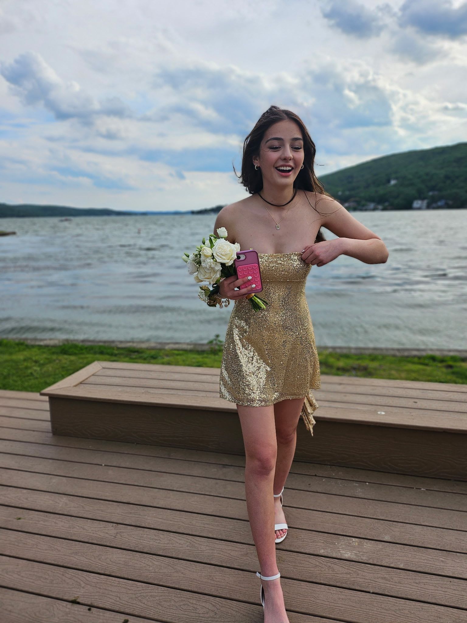 Prom 2026 - A delicate hand-tied prom bouquet designed to complement a formal gown and make the recipient feel truly celebrated. This handheld arrangement suits prom, spring formals, or bridesmaid use-offering a soft, romantic presence that reads elegant and personal rather than grand or overpowering.  Soft white roses anchor the design, paired with calla lilies, lisianthus, tulips, dianthus, hydrangeas and airy delphinium for touches of pale blue, pink, lavender and green. The bouquet is compact and slightly loose for a garden-style look, finished with white and light-blue ribbon wraps (and an optional blue ribbon accent) around the stems to echo the pastel palette. It's sized as a personal bouquet meant to be carried at the waist or in the hand.  Perfect for the person who wants a fresh, understated romantic statement-whether for prom, a spring wedding, or a lakeside photo moment. Hand-tied and ribbon-wrapped for easy carrying; we can arrange subtle variations in bloom mix or ribbon color on request to match your dress or event palette.