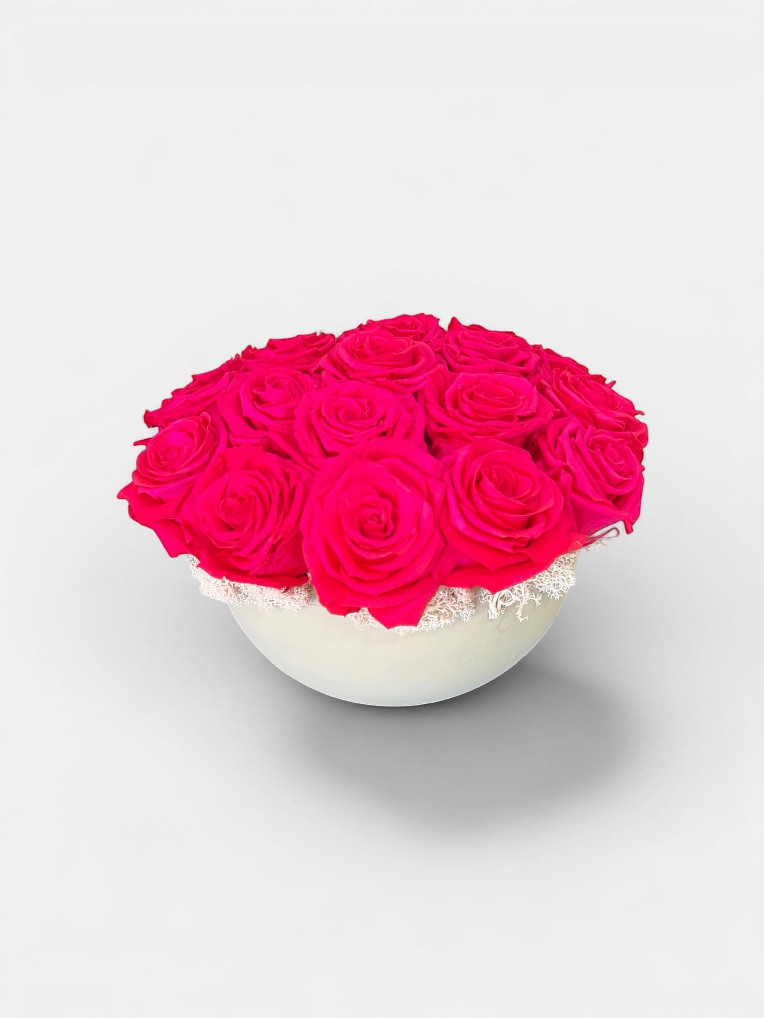 Eternal Fuchsia Blom - A vibrant arrangement of premium preserved fuchsia roses, artfully arranged in a modern ceramic vessel and designed to maintain its beauty for up to three years. Bold in color yet elegant in form, this piece adds a striking pop of luxury and long-lasting charm to any space. -no maintenance required.