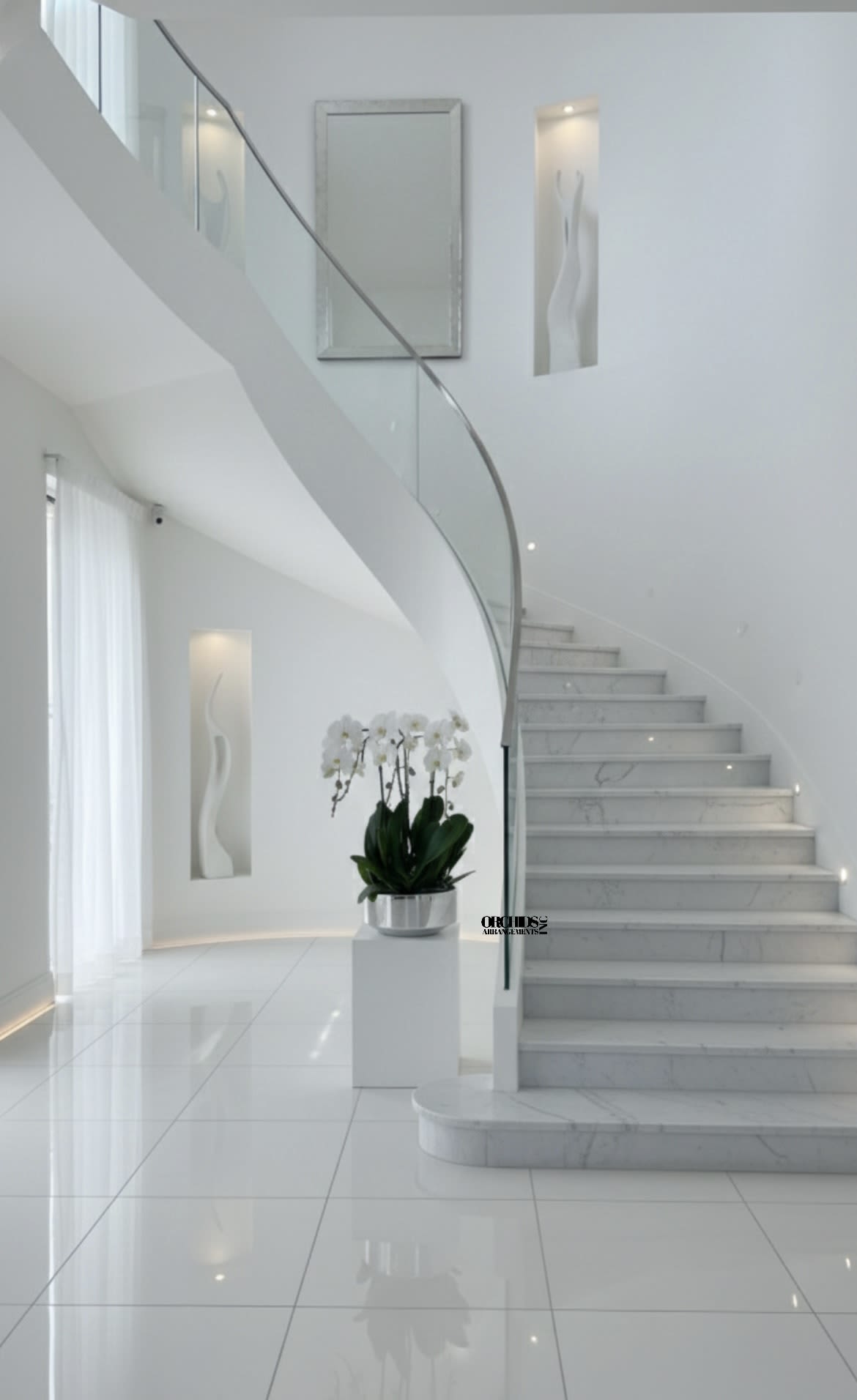 White orchid plant in a silver pot on a pedestal in a modern stairwell
