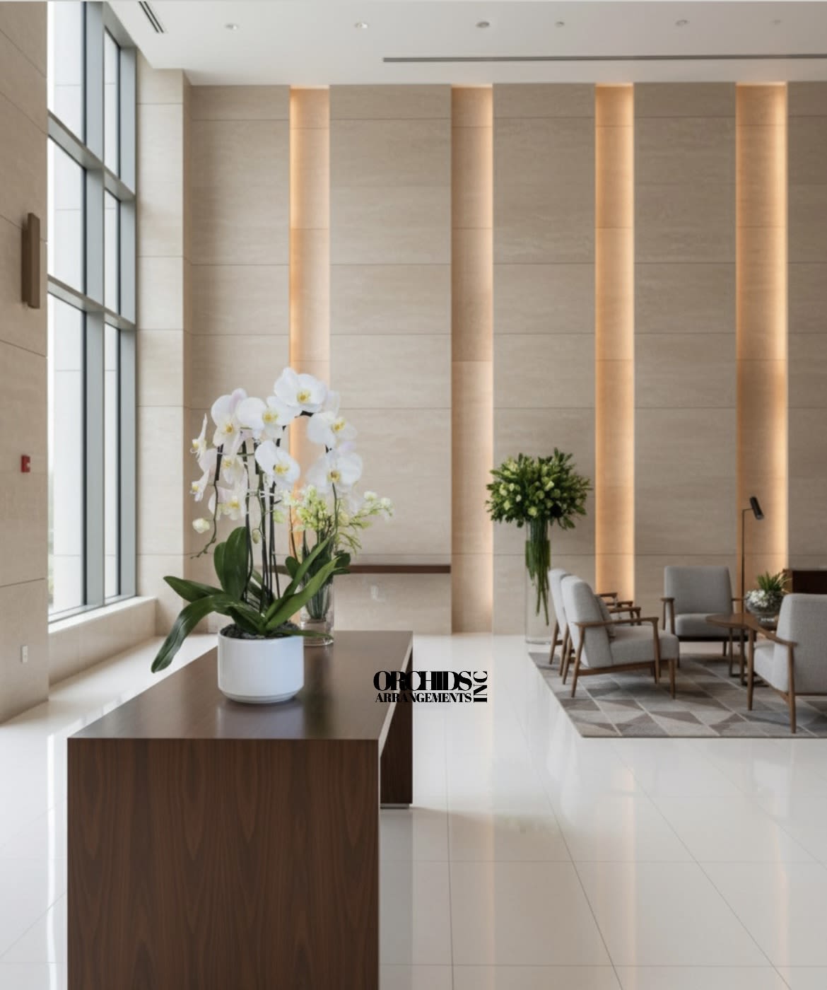 White orchids in a white pot on a wooden table in a lobby