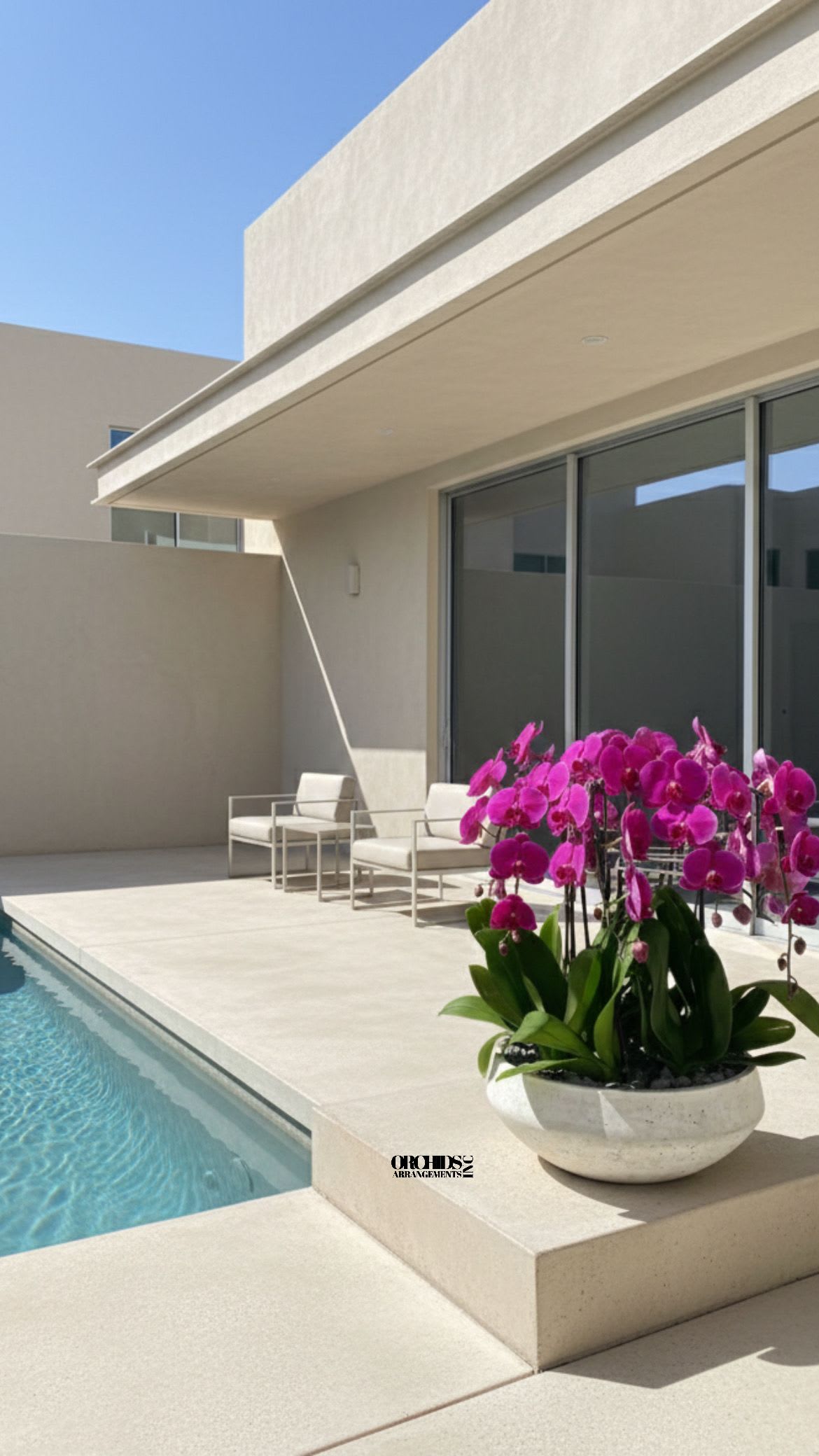 Potted pink orchids in a white bowl planter beside a pool