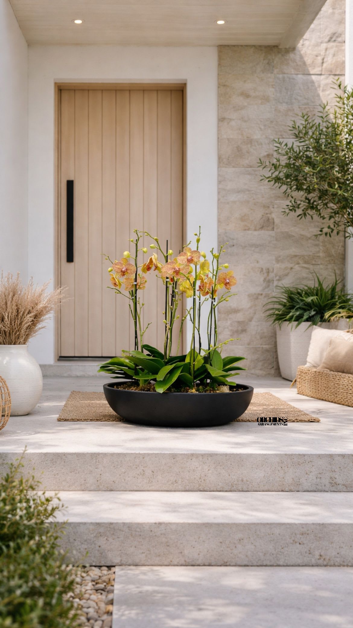 Potted orchid arrangement in a low black bowl on a porch