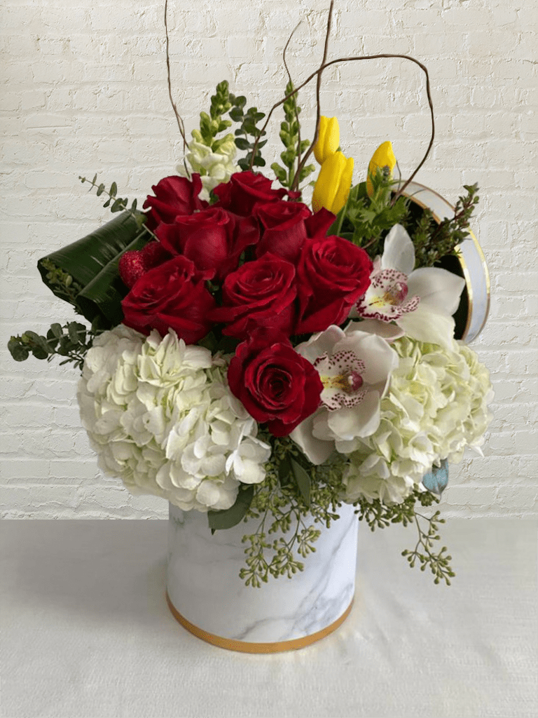 Forget Me Not - Medium 0070 - Forget Me Not is a stunning arrangement by our expert florists, true to life, and designed to add elegance to any room or office. The fresh flowers and delicate greens are delivered in a contemporary vase, a stylish finishing touch that's perfect for any occasion. Includes 8 abundant roses in a magnificent mixed bouquet with unique seasonal blooms express the designer's signature style. Forget Me Not is a timeless gift for any occasion.