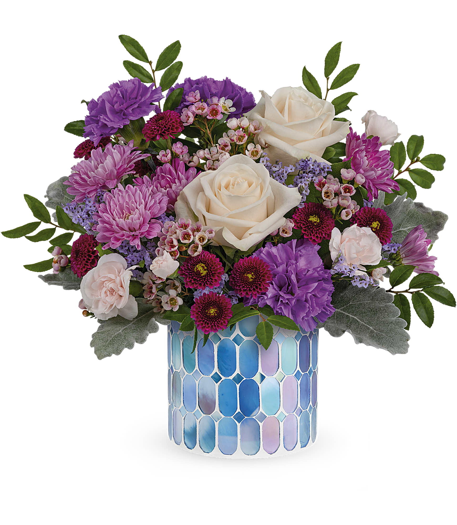Blue Beauty Bouquet - Springtime beauty at its best! Creamy roses and deep purple blooms are oh-so-alluring in this shimmering, stained glass mosaic vase. Crème roses, purple carnations, miniature light pink carnations, lavender cushion spray chrysanthemums, purple button spray chrysanthemums, pink waxflower and purple limonium are arranged with dusty miller and huckleberry. Delivered in Teleflora's Blue Beauty Mosaic vase. Approximately 13 3/4" W x 12 3/4" H 