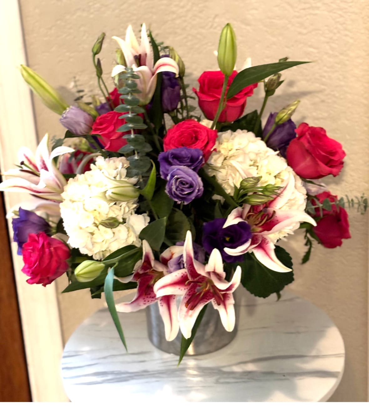 Luxury Lily &amp; Rose Arrangement - An elegant flower arrangement in San Antonio featuring fresh stargazer lilies, red roses, hydrangeas, lisianthus, eucalyptus, and premium seasonal blooms beautifully designed in a modern container. Handcrafted by Snyder Flowers San Antonio, this luxurious floral arrangement combines romantic colors and sophisticated textures perfect for anniversaries, birthdays, sympathy, romantic surprises, or special occasions.   We proudly offer same-day flower delivery in San Antonio with fresh premium flowers and exceptional customer service.  Luxury floral designs created with high-quality roses, lilies, hydrangeas, and elegant garden-style arrangements.  Serving Stone Oak, Medical Center, Alamo Heights, Cibolo, Universal City, Live Oak, Helotes, Castle Hills, Shavano Park, and Downtown San Antonio.  Looking for a trusted florist in San Antonio, same day flower delivery, or luxury flower arrangements near you? Snyder Flowers creates elegant handcrafted floral designs delivered fresh and beautifully arranged for every special moment.
