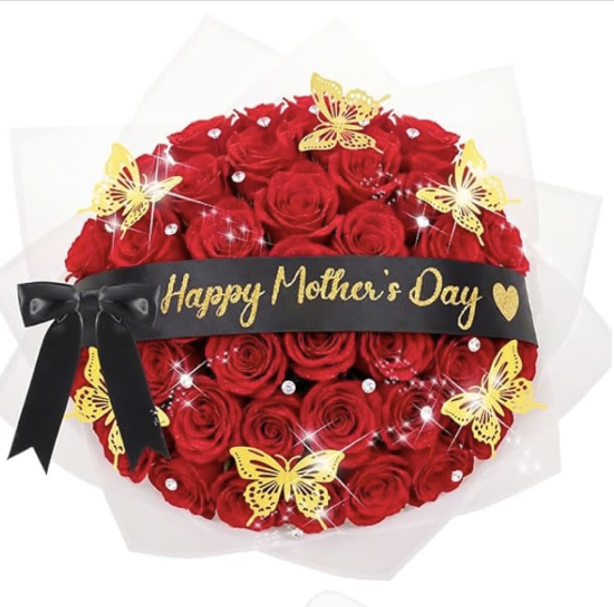 Golden Love Mother’s Day Bouquet - A bold, gift-like bouquet of red roses crafted for Mother's Day, this arrangement announces celebration with dramatic contrast: deep red roses clustered into a dense, round shape wrapped in translucent paper and banded with a wide black ribbon that reads "Happy Mother's Day" in gold. The striking red-and-black palette reads both romantic and celebratory, so the person you're thinking of will feel honored and adored the moment they see it.  Bright yellow butterfly picks and sparkling rhinestone accents flutter through the spray, adding cheerful color and delicate shimmer against the velvety rose petals. A tied black bow completes the presentation, and the compact, hand-deliverable size makes it perfect for placing on a table or bedside. Materials include the roses, decorative butterfly picks, rhinestone accents, clear wrapping, and the black ribbon with gold lettering.  Perfect for a mother, wife, or special woman who appreciates classic red roses with a modern, embellished twist-this bouquet says "you are celebrated" for Mother's Day, anniversaries, or a meaningful birthday. Because it's arranged tight and wrapped for delivery, no vase is required; keep the stems in water on arrival and change the water every other day to help the roses last.