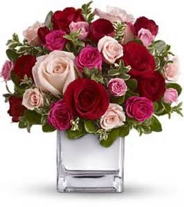 Sweet Stuff - Half a dozen red and pink pink roses with pink and white miniature carnations arranged in a  rectangular vase with pretty filler flowers and a fresh variety of greens added to compliment this sweet design! 