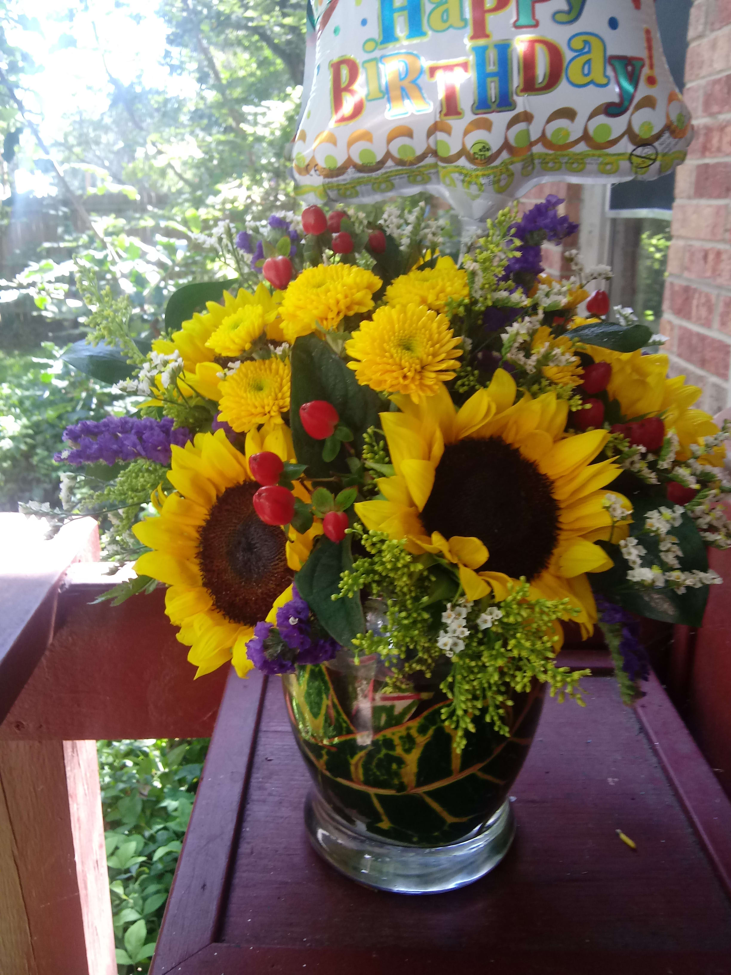 Sunny Days - A bright sunny vase of sunflowers with red, purple and yellow filler flowers added to make this a fun festive floral design for a birthday or any occasion!