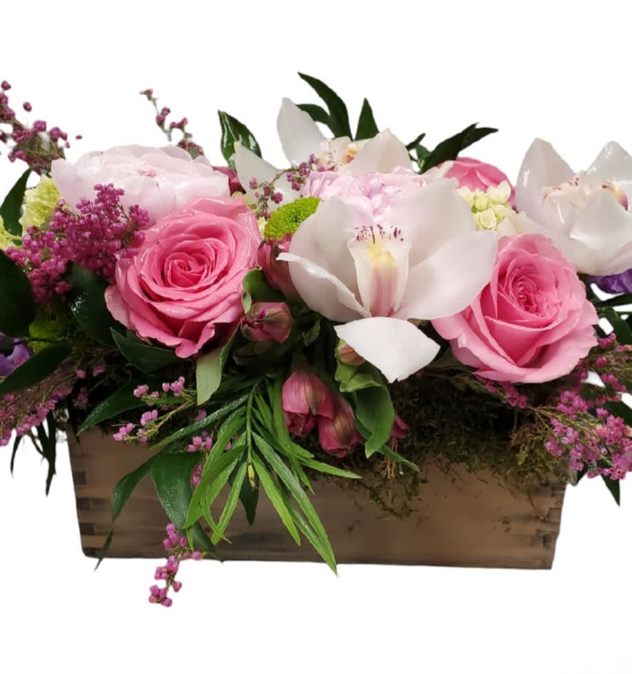 Pink roses and white orchids arranged in a wooden box