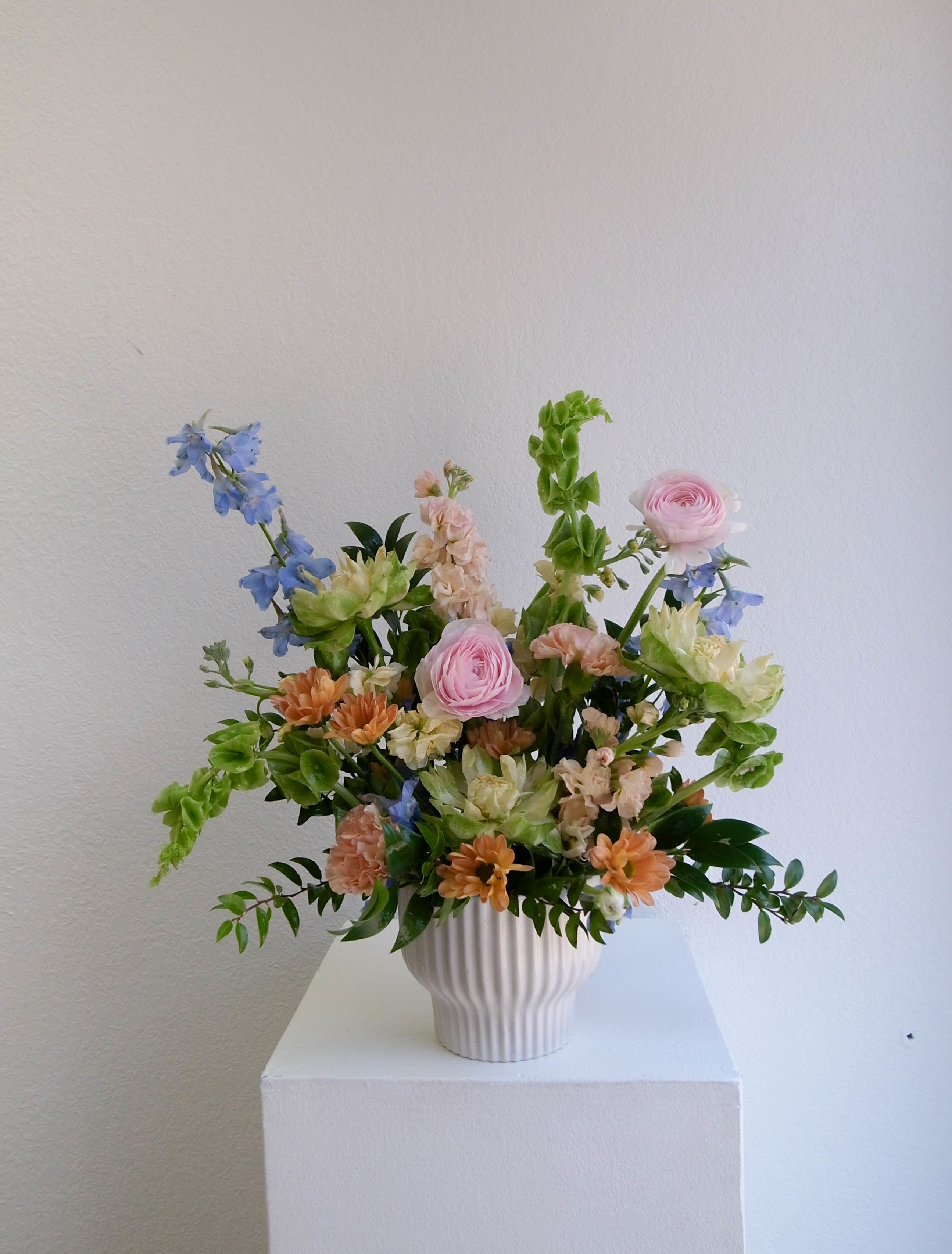 Petite Designer's Choice  - Our Designers Choice Arrangement is a thoughtfully curated design that celebrates love in its most timeless form. Each piece is artfully created by our floral team using the season’s best blooms, allowing natural movement and texture to shape every arrangement.