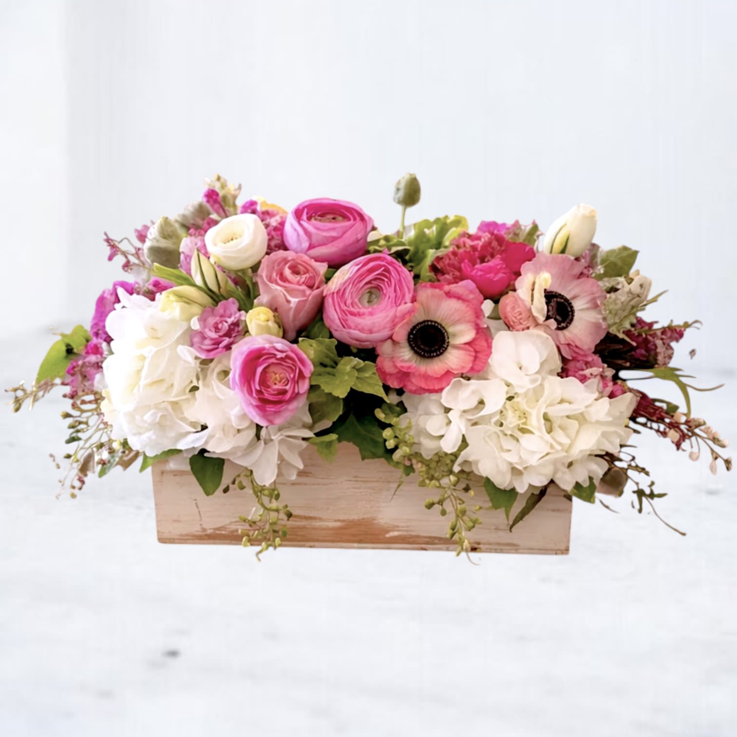 Bubblegum - Playful, bright, and full of charm, Bubblegum features a cheerful mix of pink ranunculus, roses, anemones, and creamy white hydrangea arranged in a lush, garden-inspired design. With its soft layers, airy texture, and vibrant pink tones, this arrangement brings a fresh, modern twist to everyday flower delivery.  Designed in a rustic wooden box, it’s perfect for birthdays, get well wishes, thank you gifts, or sending something fun and uplifting. Available for same-day flower delivery.