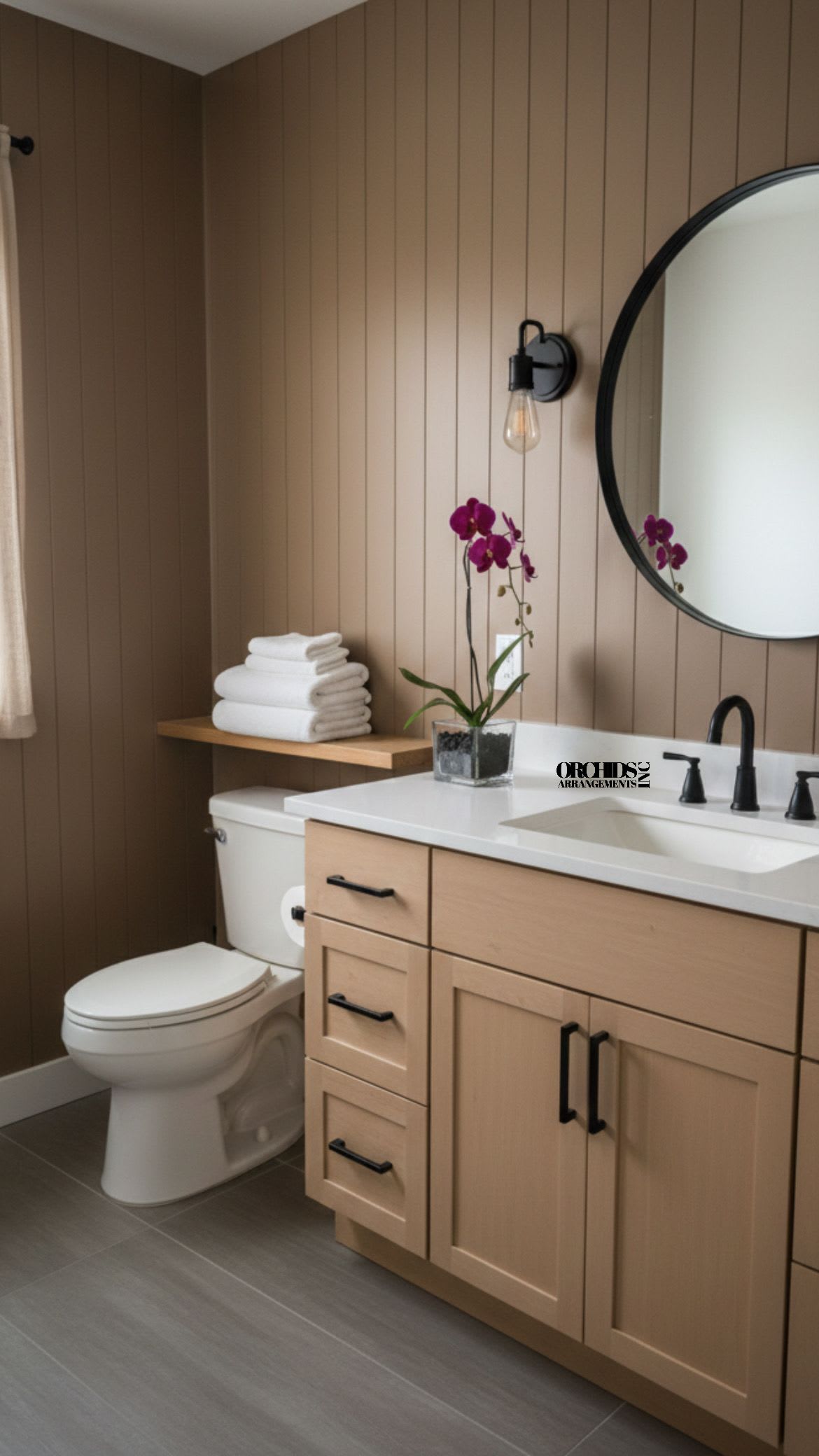 Purple orchid in a square glass vase on a bathroom counter