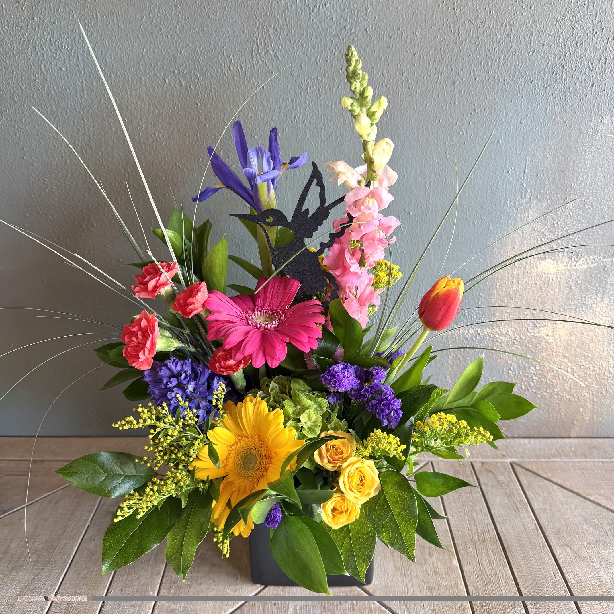 Hummingbird - The playful hummingbird theme and contemporary low black container make this arrangement feel modern and garden-fresh!