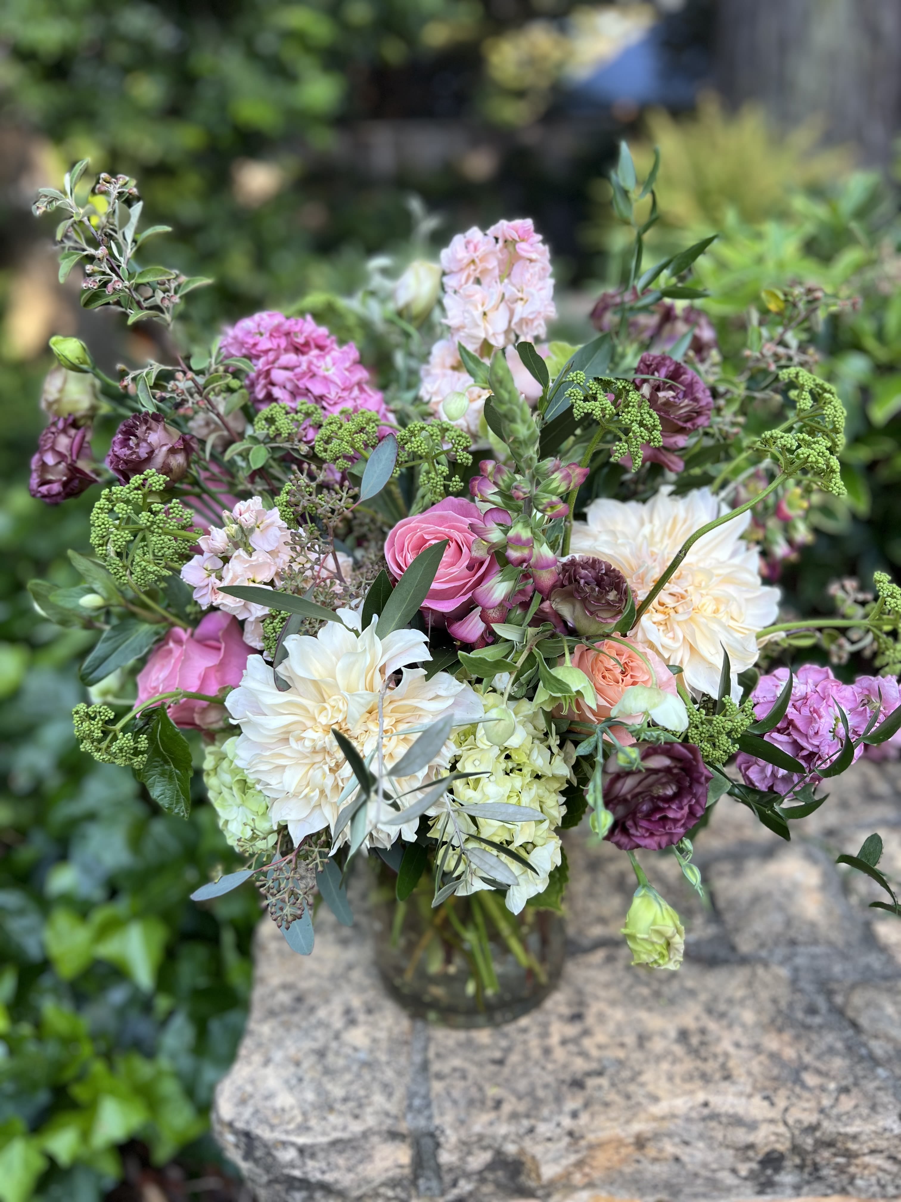 Hillsborough Heights  - Grand and stunning, this showstopper is filled with green hydrangeas, viburnum, cafe au lait dahlias, pink roses, plum lisianthus, foxglove, and mauve stock; great for an entry or a statement piece on a credenza. 