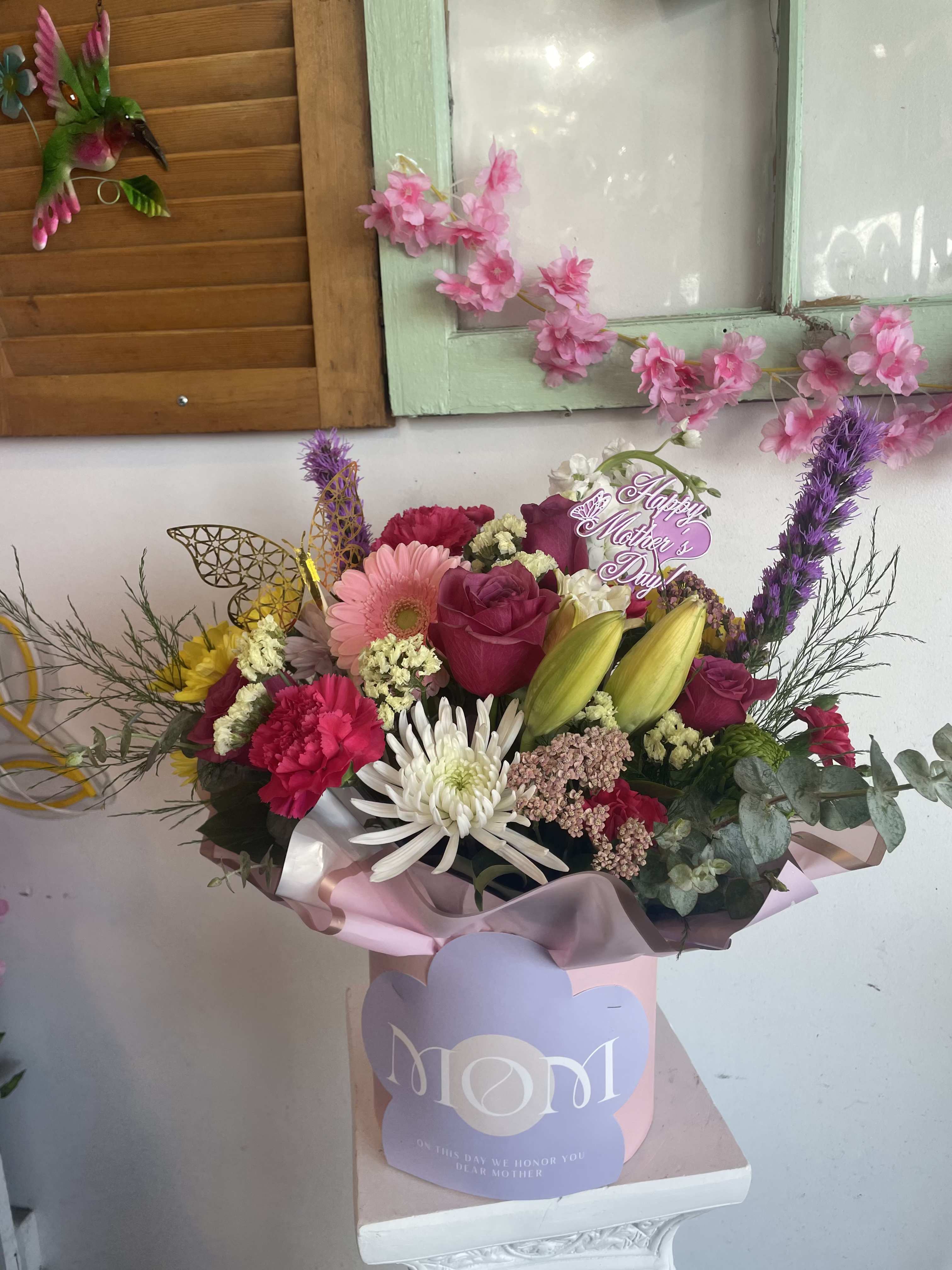 Mothers Day Box  - Full mixed pink, white, purple, and yellow blooms - roses, gerbera, lilies, carnations in a gift box with mothers day sign. Comes with a complementary butterfly. 
