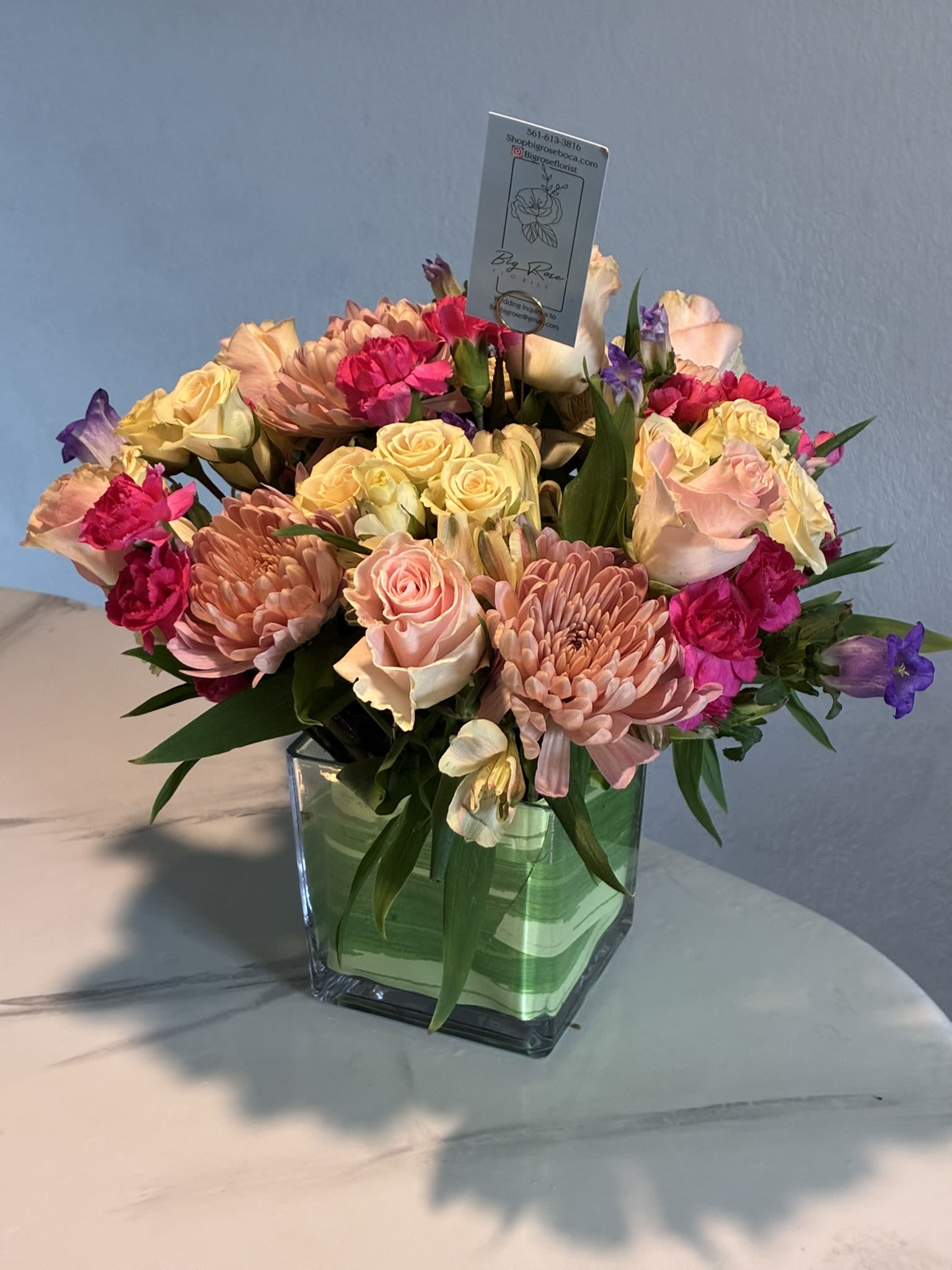 Pink Magic - Assorted Pink blooms in a tai leaf wrapped vase