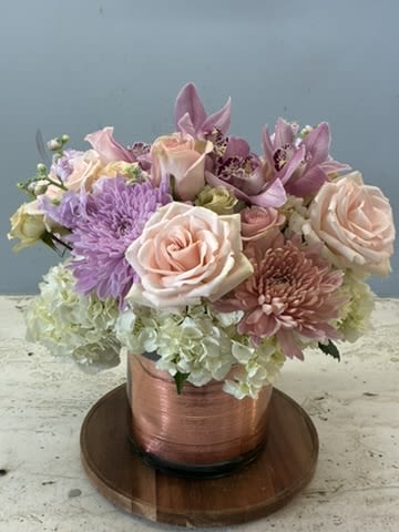 Blushing  - Our large and sleek cylinder clear vase filled with white hydrangea blush and Ivory roses.