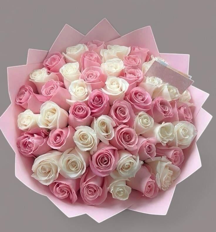 Happy Moher's Day - A lush dome of tightly packed pink and white roses creates an immediate impression of warmth and appreciation-perfect as a Mother's Day bouquet or a birthday bouquet for the woman who deserves to feel cherished. The hand-tied arrangement reads as both romantic and gently celebratory, the pastel rose tones sending a soft, loving message that makes the recipient feel seen and adored.  This dense bouquet features an abundant mix of pink and white roses arranged in a rounded, classic silhouette and finished with layered pink paper wrap for a polished, gift-ready presentation. The compact, dome shape highlights the roses' velvety petals and subtle fragrance while keeping the look refined and elegant-ideal for sending to a mom, partner, or close friend who appreciates timeless floral style.  Because of its versatile palette and generous rose count, this arrangement works beautifully for Mother's Day, anniversaries, birthdays, or simply to say you're thinking of her. The hand-tied design arrives ready to display; trim stems, place in clean water, and refresh the water and floral food to extend bloom life.