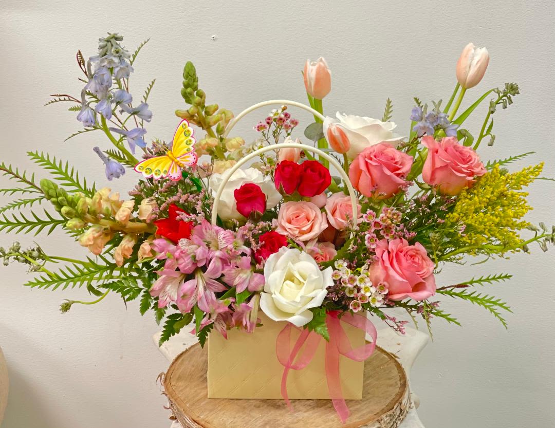 Mixed bouquet of roses, tulips, and alstroemeria in a gift box