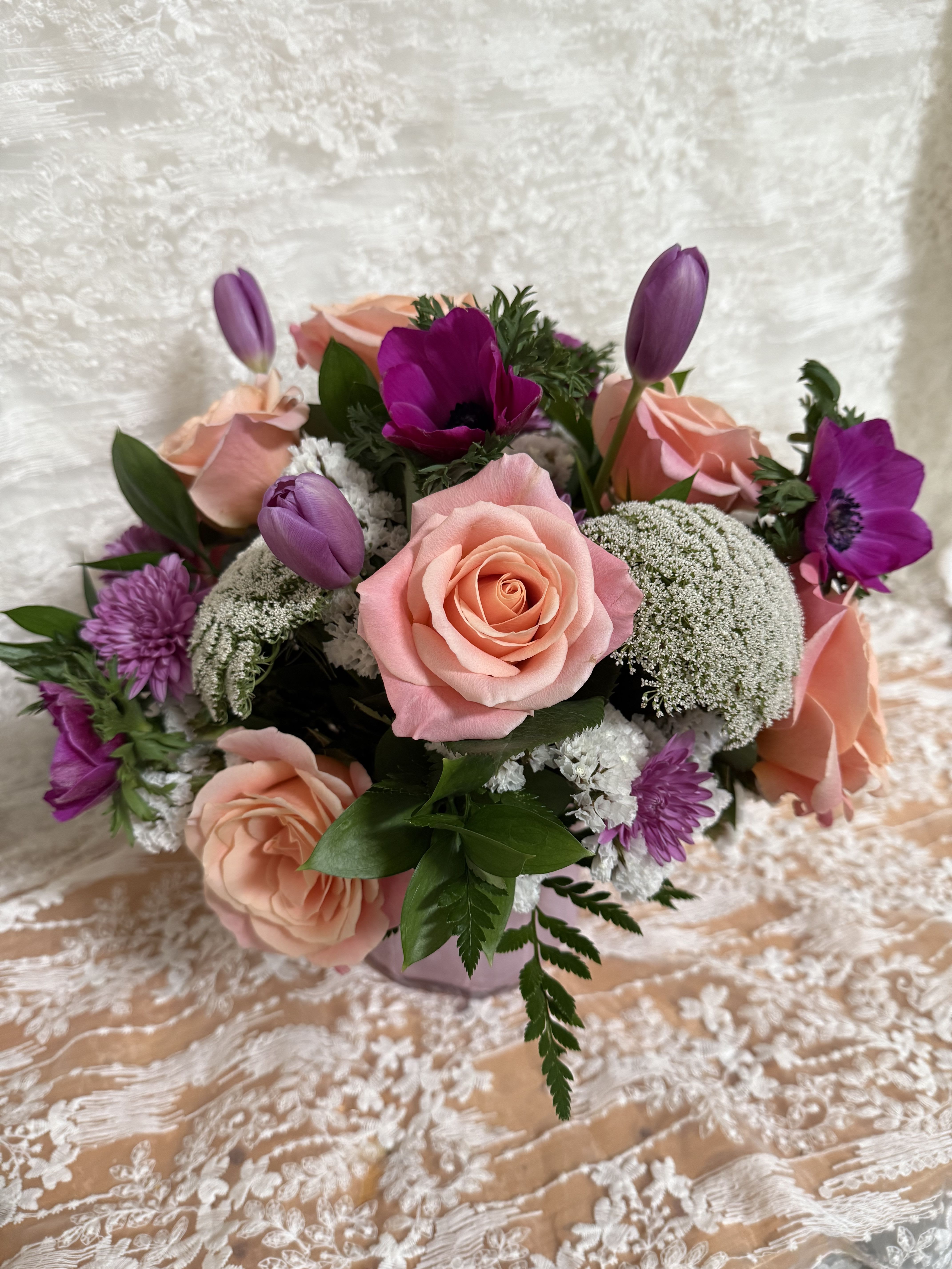 Mothers Day Pink designers choice - Florist will create a beautiful arrangement with pink and purple flowers in a pink vase 