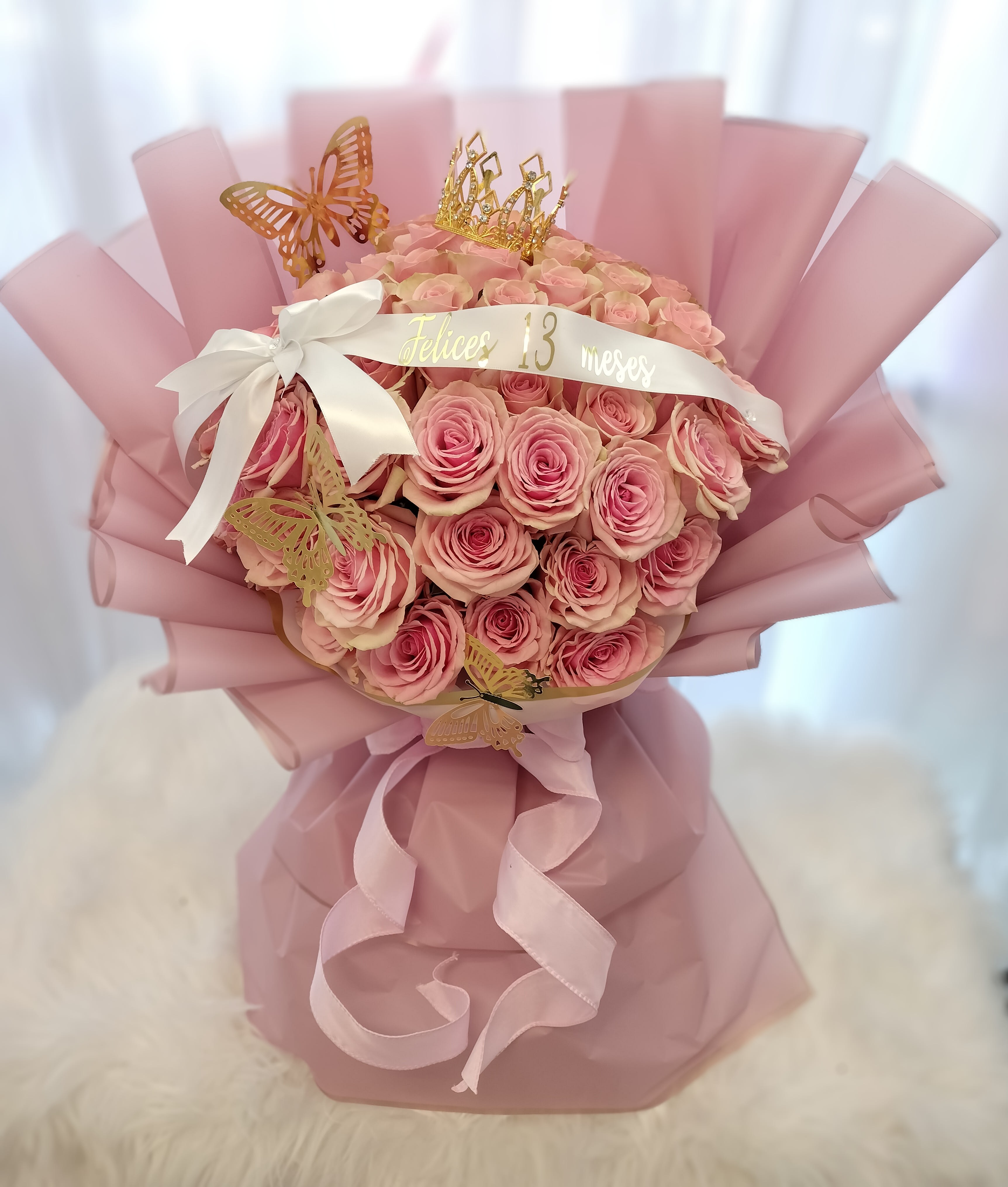 Pink rose bouquet with a crown and butterfly decorations