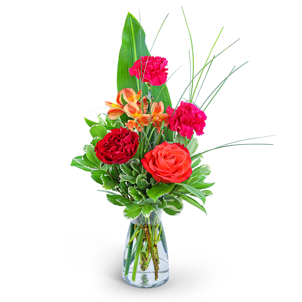 Mixed bouquet of roses, carnations, and orange blooms in a glass vase