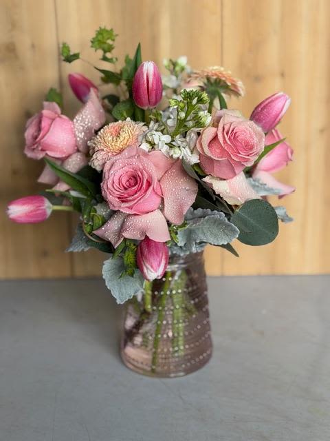 Pink Delight - Soft pink roses and pink tulips take center stage in this romantic birthday bouquet and Mother's Day arrangement, designed to make the person you're thinking of feel cherished. The gentle pink palette is brightened by delicate white filler blooms and touches of silvery foliage, while hints of soft purple and fresh green add depth-an ideal choice for anniversaries or to say "thinking of you" without being over the top.  .