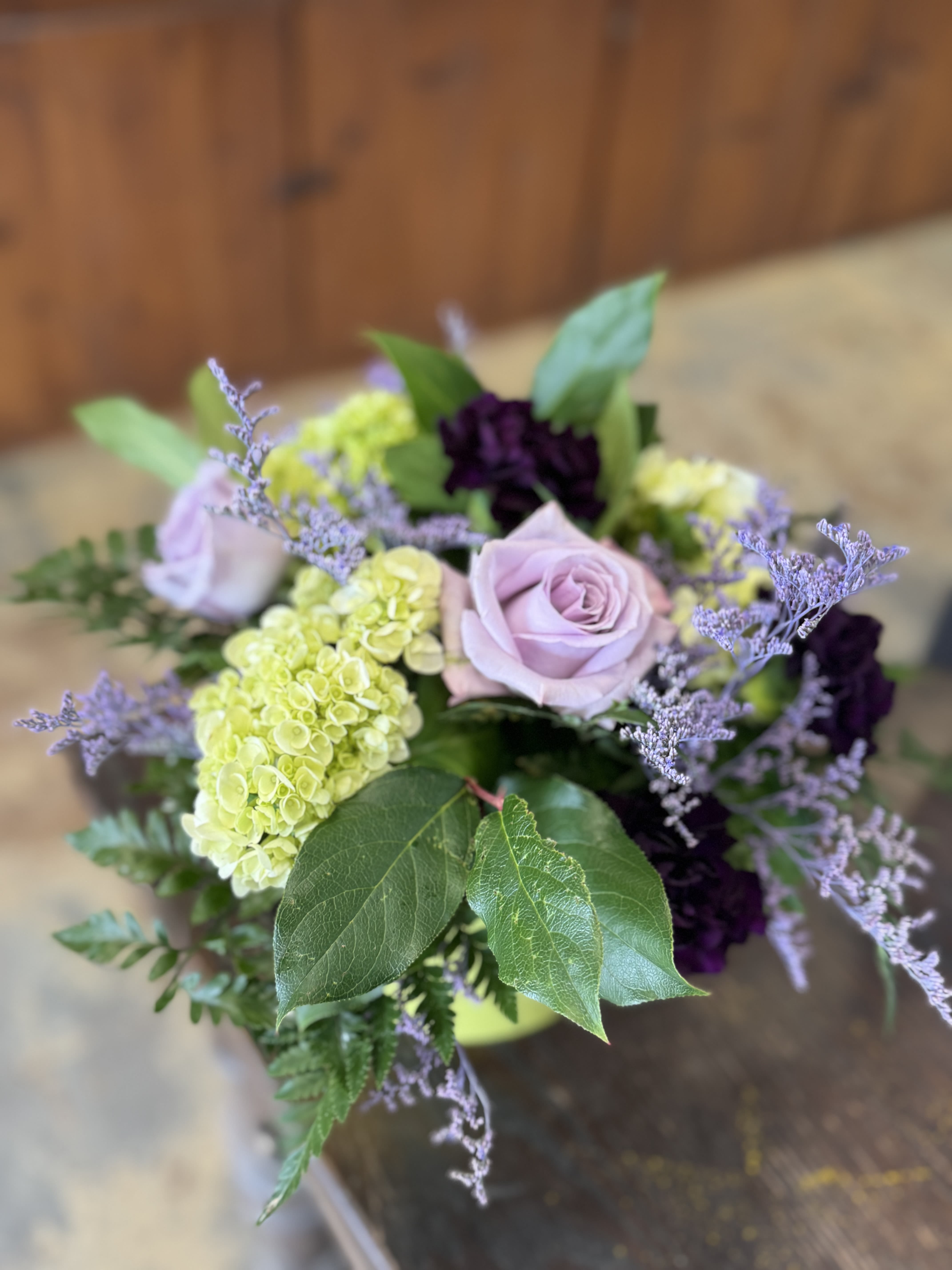 Lavender Grace - A charming Mother’s Day bouquet filled with soft lavender roses, fresh green hydrangeas, deep purple accents, and lush greenery. Sweet, elegant, and made to brighten Mom’s day!