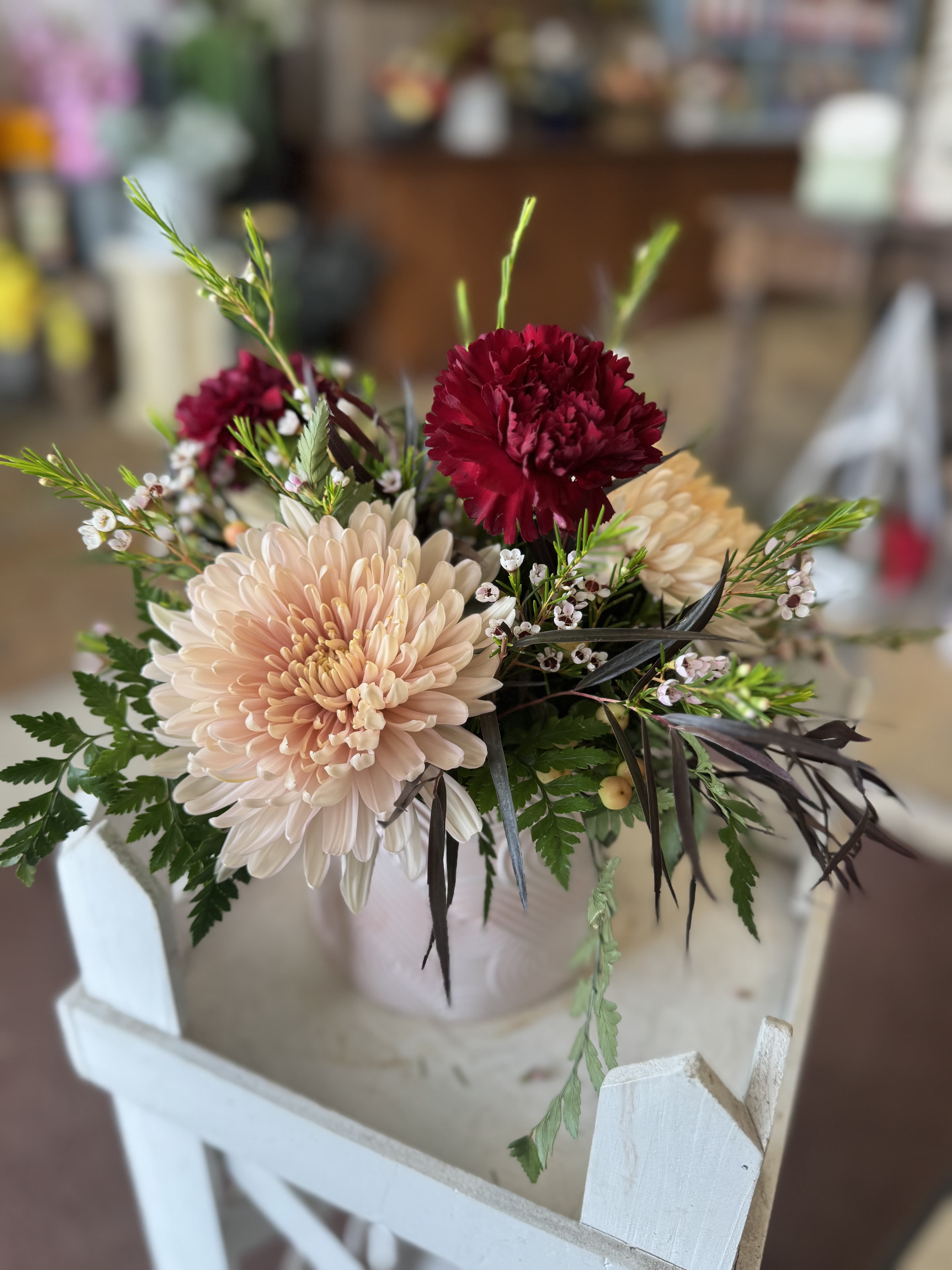 Sweet as a Peach - A soft and lovely Mother’s Day bouquet featuring peach-toned blooms, rich burgundy accents, delicate filler flowers, and fresh greenery. Sweet, charming, and perfect for celebrating Mom.