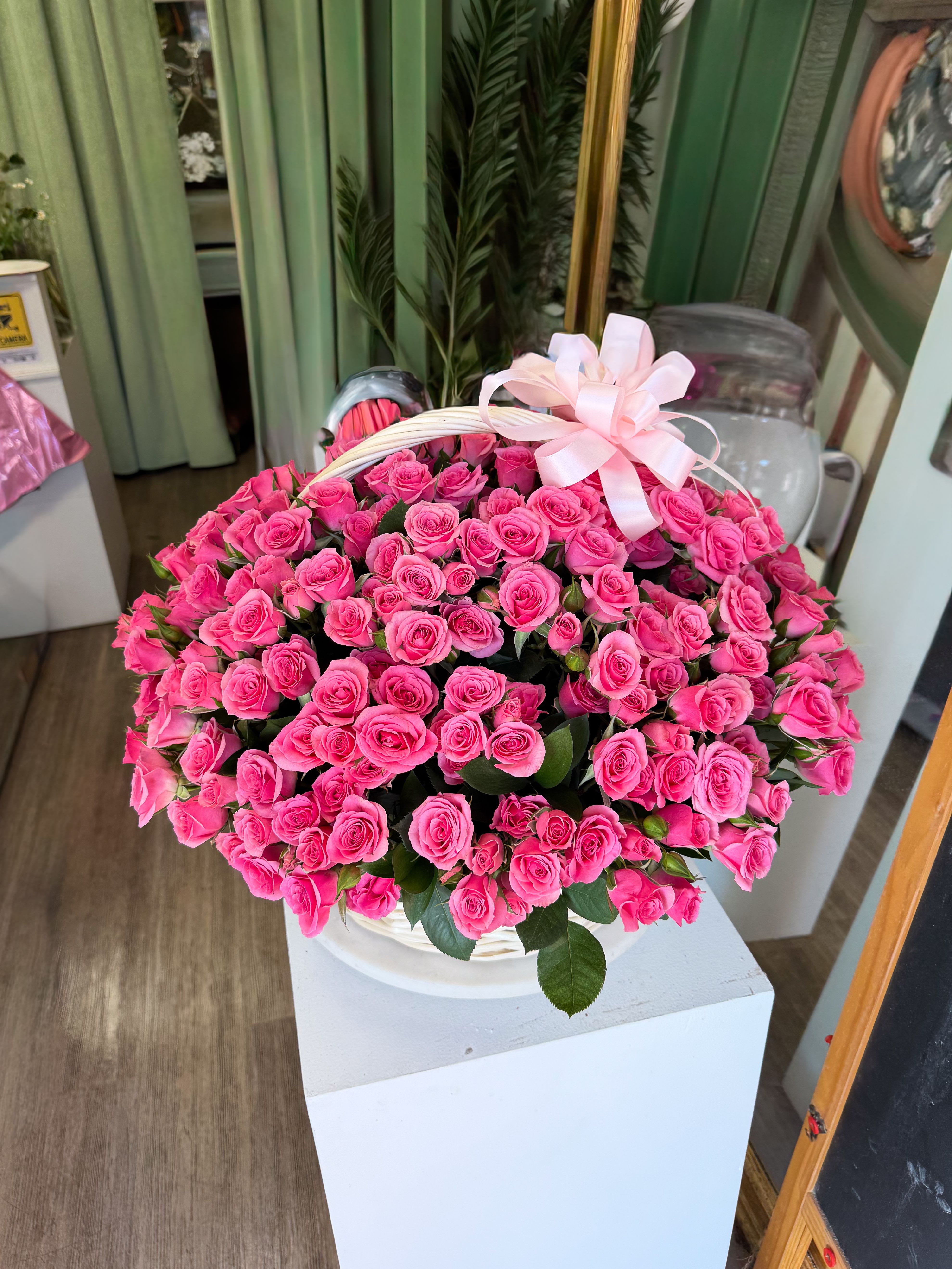 Pink Billionaire Basket - An ultra-lush basket overflowing with premium hot pink spray roses, designed in a dense, dome-style composition for maximum impact. “Pink Billionaire” is all about volume and precision — hundreds of delicate blooms placed tightly together to create a rich, velvet-like texture that feels extravagant from every angle. Finished in a classic white basket with a soft ribbon accent, this piece is bold, feminine, and unapologetically luxurious — made for moments when you want the gesture to speak louder than words. Perfect for grand celebrations, statement gifts, or high-end romantic gestures.
