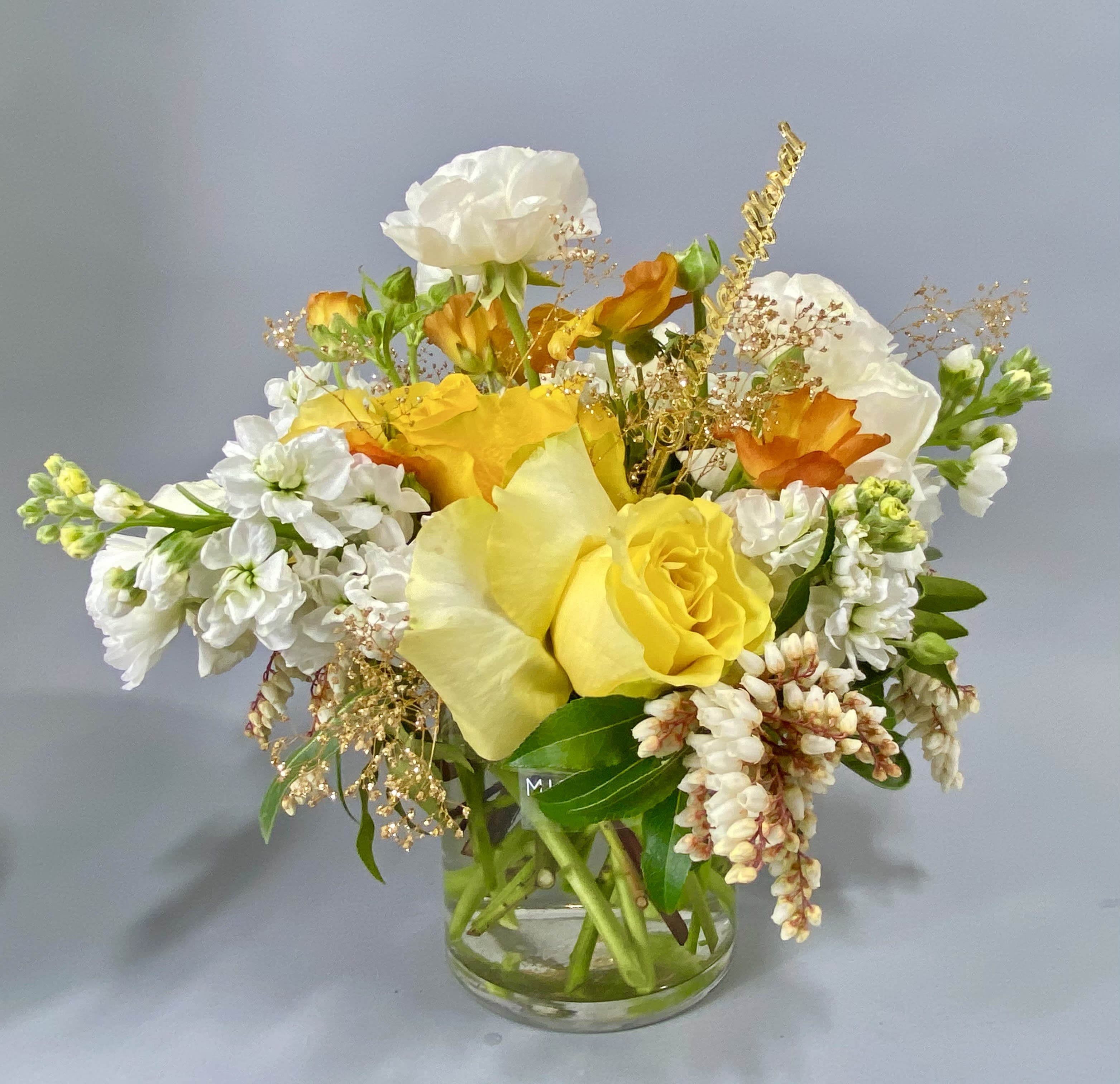 Mellow Yellow  - Dive into a world of color and fragrance with this arrangement. Bright hues of yellows, oranges, and soft whites paired with fresh stock with an aroma unlike any other. Perfect for the house or to send to a friend!