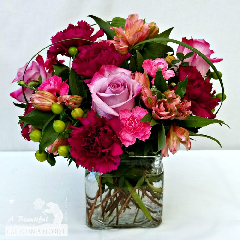 Be Bold Bouquet - Be Bold Bouquet a beauty with a bold exclamation! A collection of premium blooms in a modern square vase. Fits well on a desk or end table.  