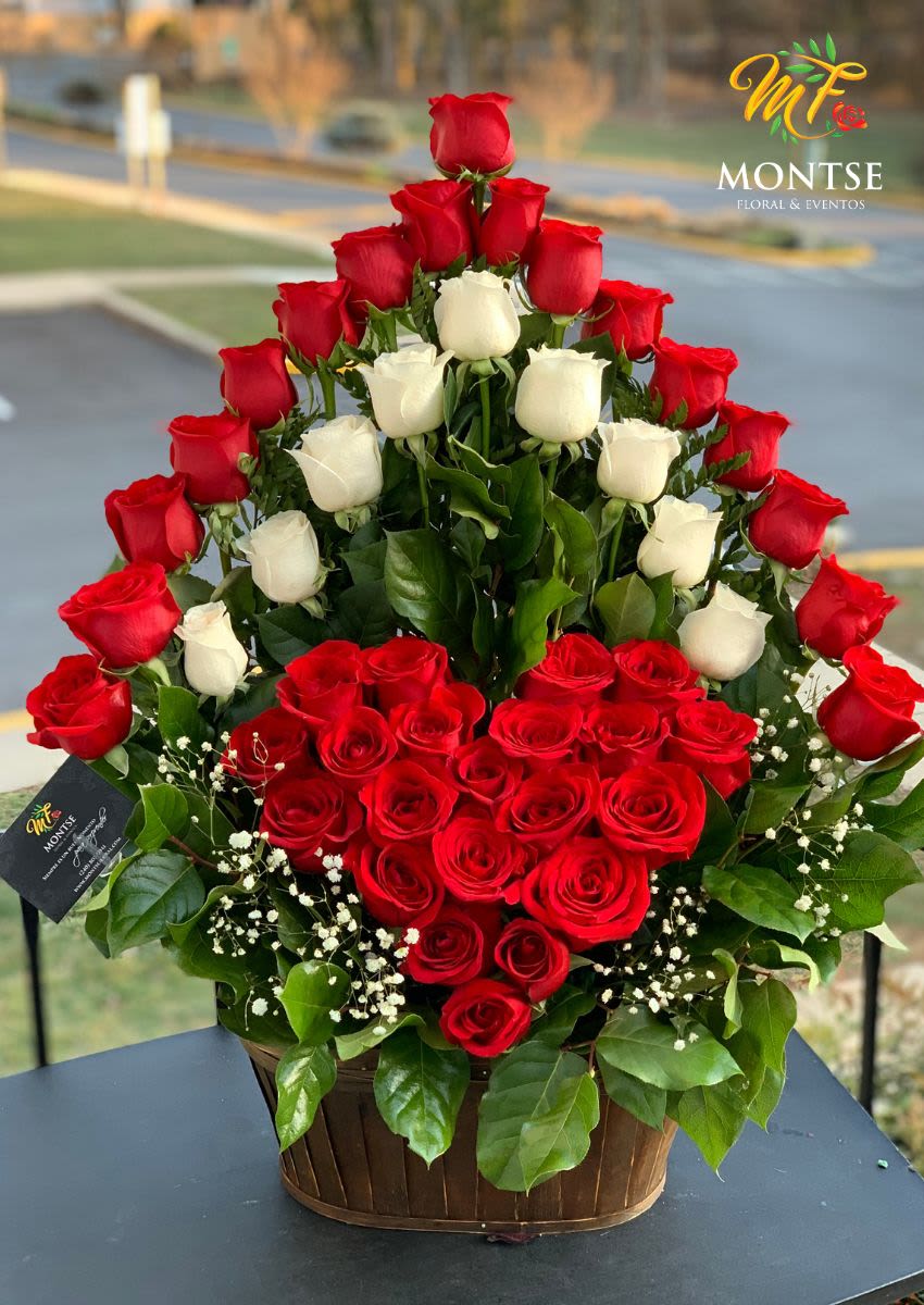 Heart-shaped arrangement of red and white roses in a basket