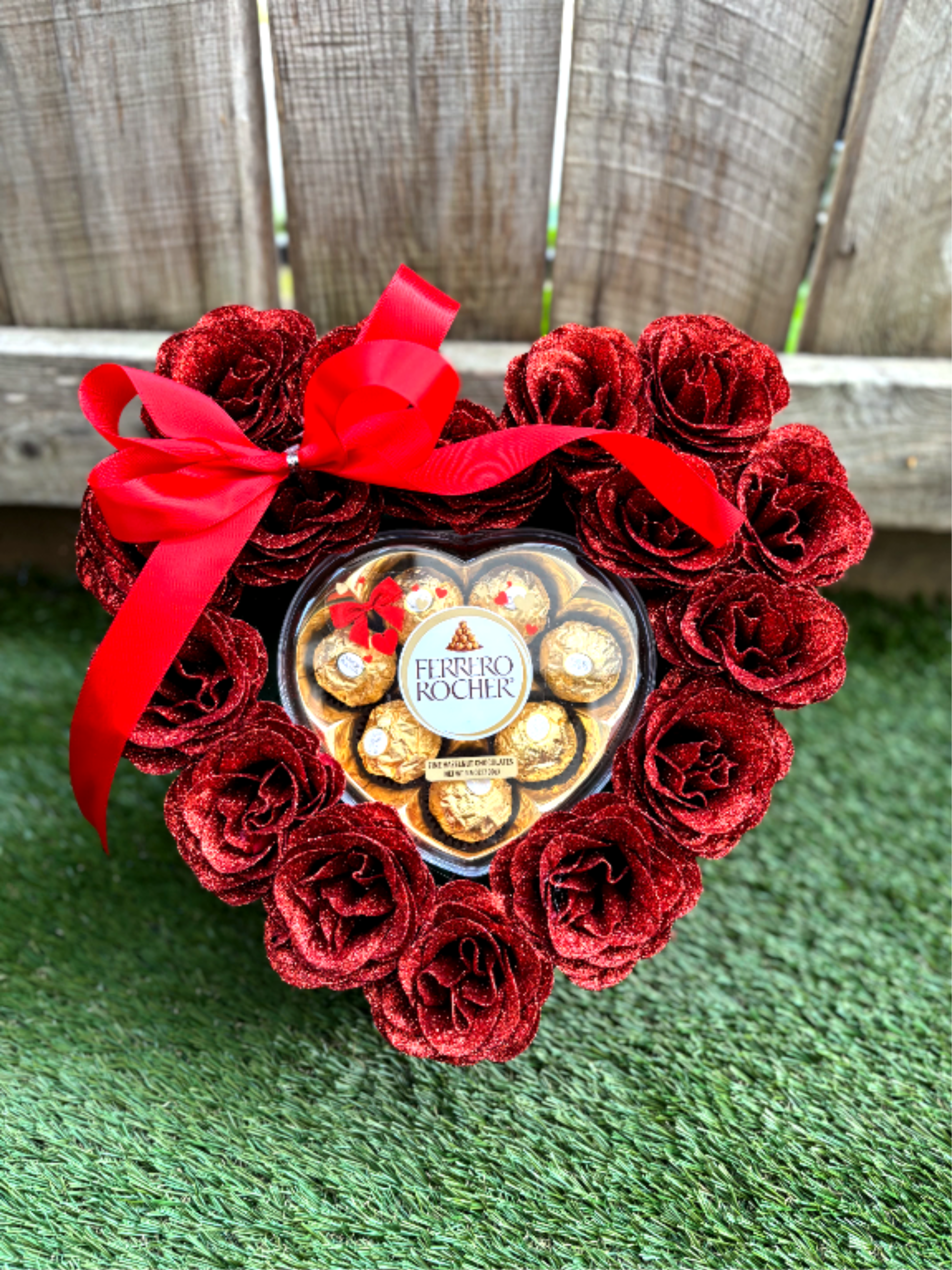 Love you baby  - A heart-shaped arrangement of glittering red roses surrounding a selection of Ferrero Rocher chocolates.