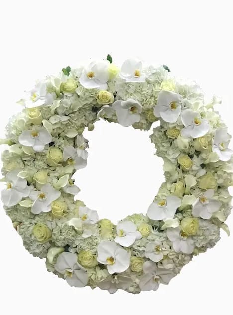 White floral wreath with orchids and pale green blooms