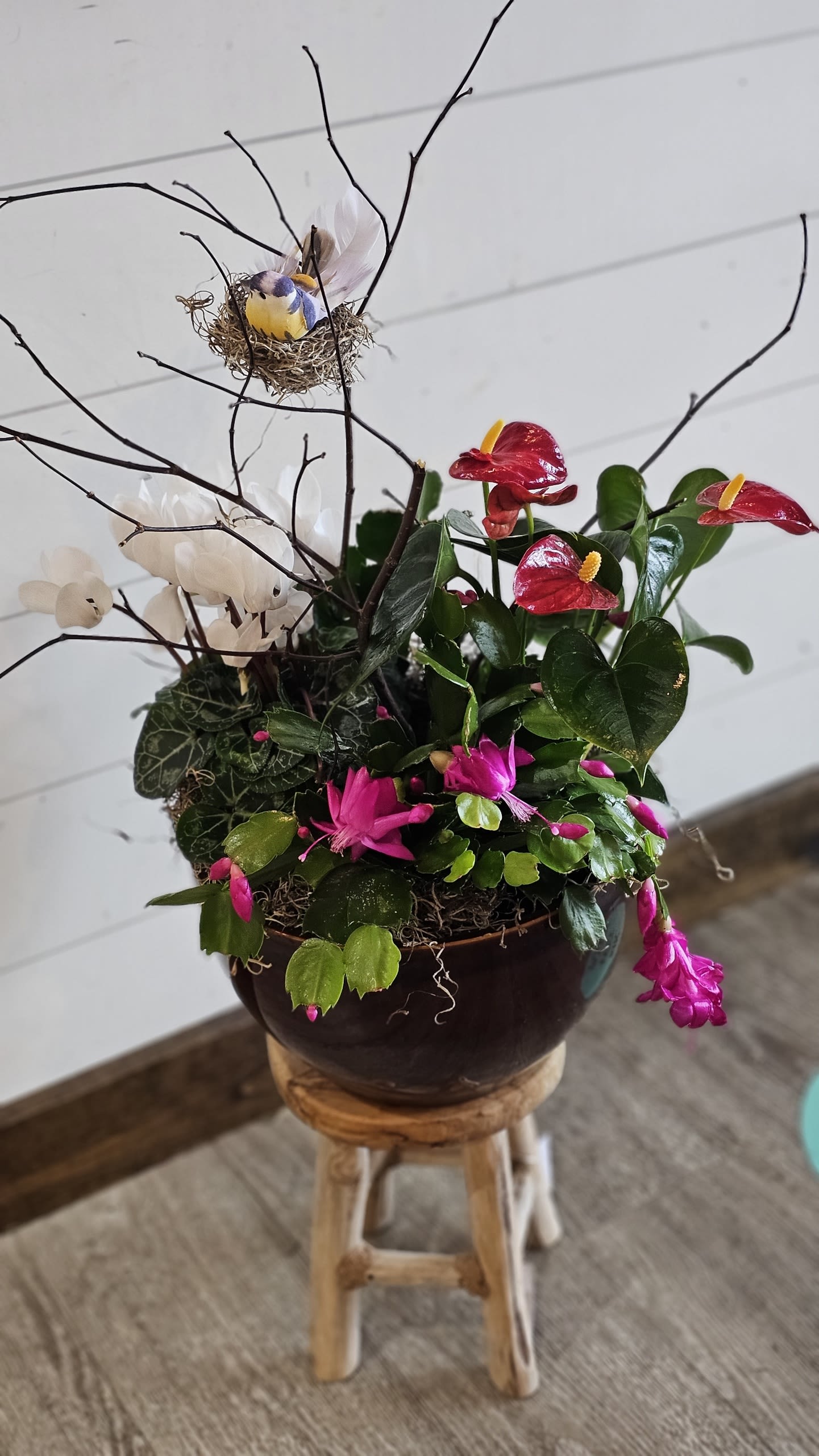 Potted floral arrangement with red anthuriums, pink blooms, and white flowers