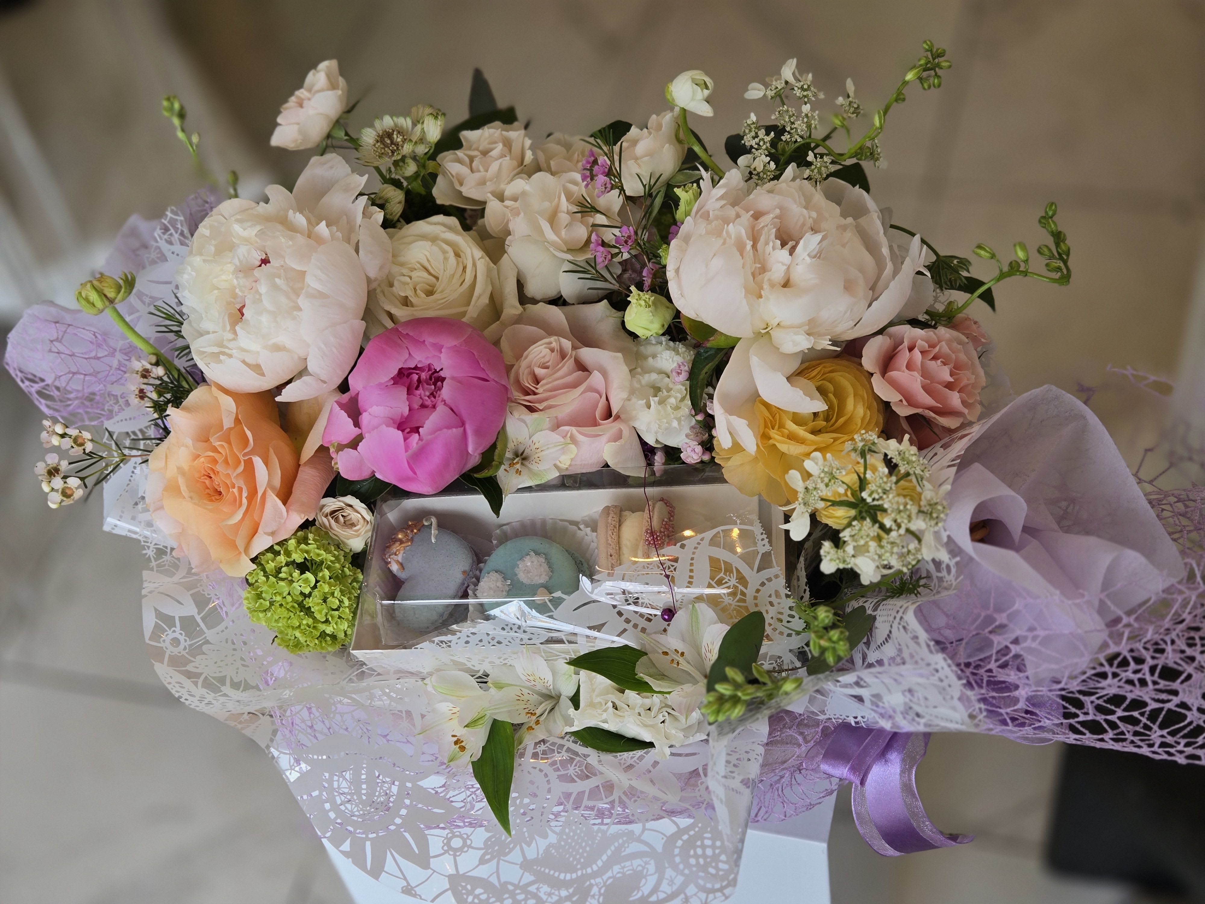 MD Arrangement - 2 - A special Mother’s Day flower basket paired with delicate macarons, creating a sweet and thoughtful gift. Perfect for celebrating Mom with both beauty and a delightful treat.  Limited availability — only 5 left