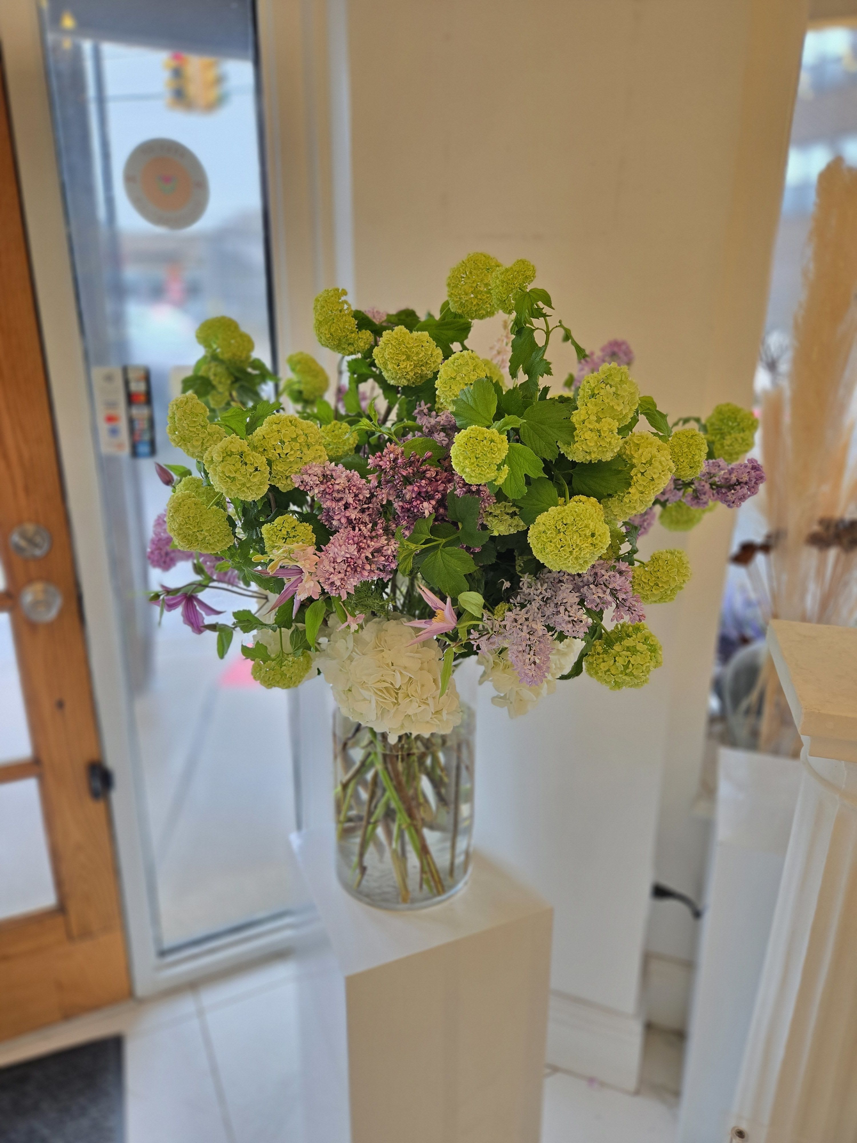 MD Arrangement- 5 - A tall and large Designer’s Choice arrangement, crafted with the finest seasonal blooms in a full, statement design. Perfect for those looking to make a grand and unforgettable impression this Mother’s Day.