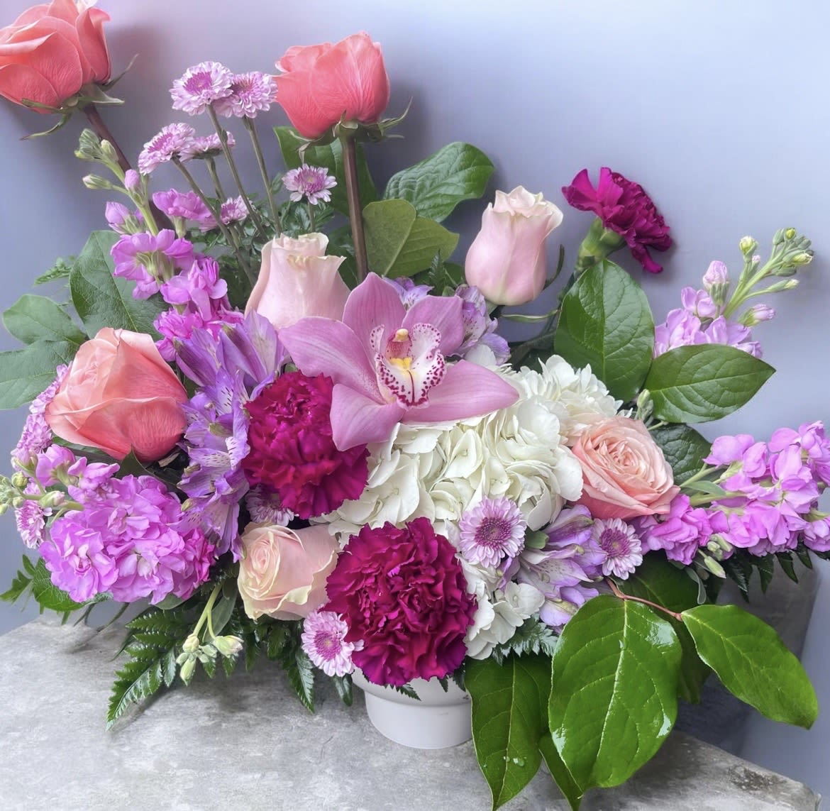 The Lush Garden  - This arrangement has roses, hydrangea, stock, carnations, and orchid and greenery.