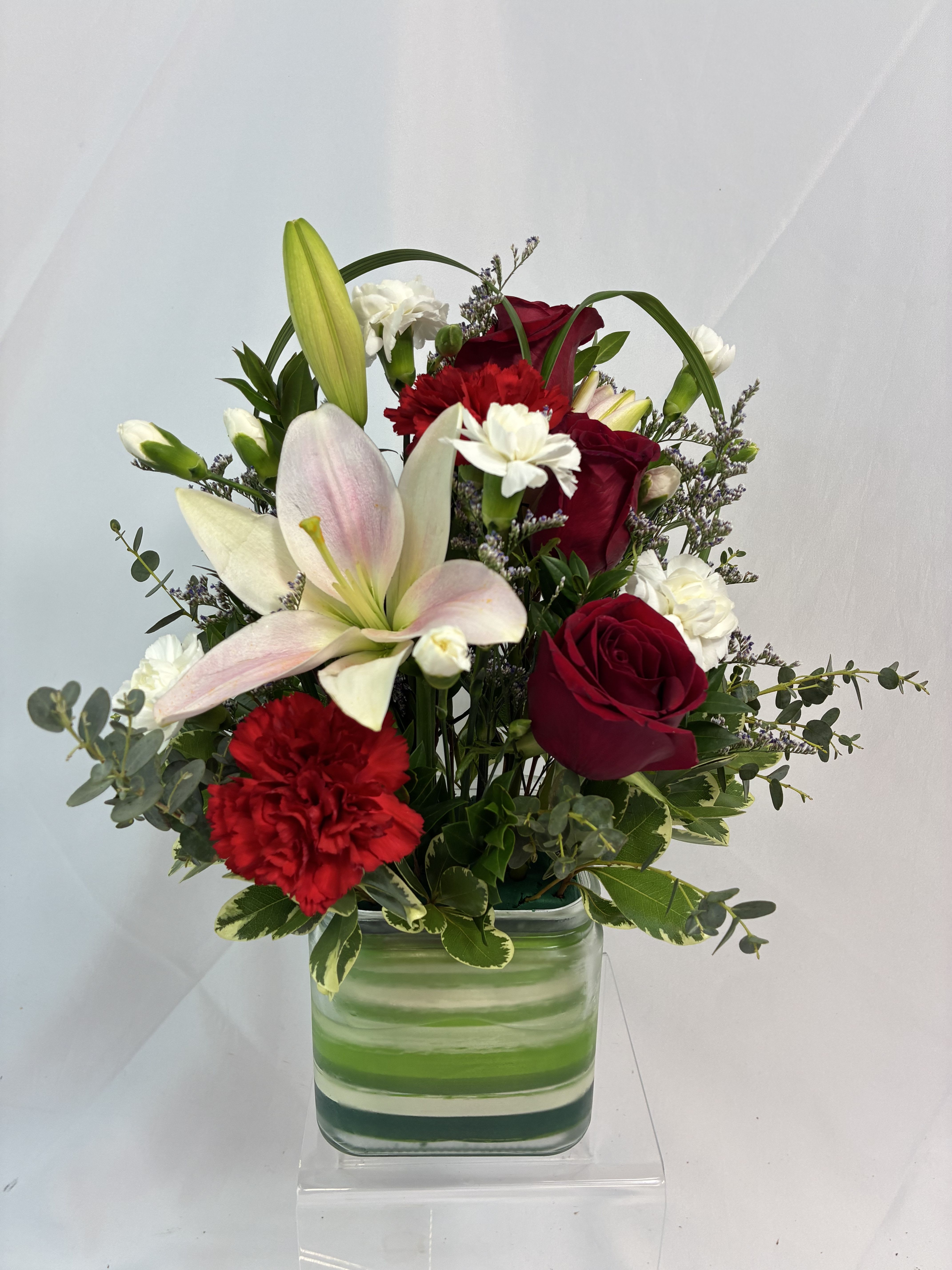 Joy of Lily &amp; Rose Bouquet  - Beautiful Lilies meet classic Freedom red Roses in a modern glass cube vase, accented with an Aspidistra leaf. Pink, red and white create a classic color trio and elegantly styled to send lots of joy!! 